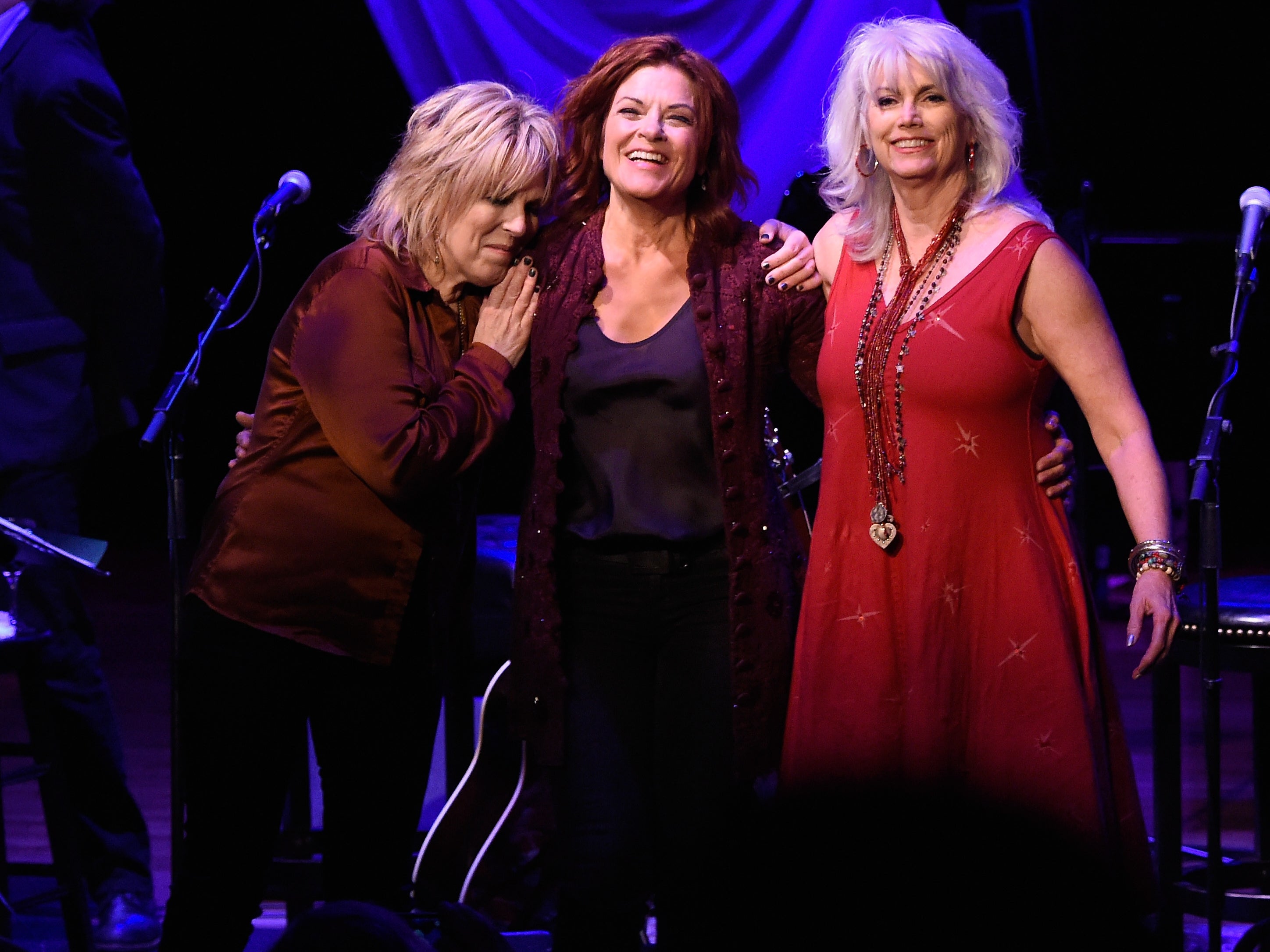 Lucinda Williams, left, onstage with Rosanne Cash, centre, and Emmylou Harris, 2015