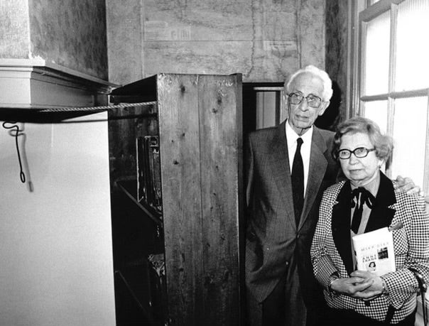 Miep and Jan Gies, years later, stand by the bookcase that hid a secret entrance to the hiding place of Anne Frank, her family and four others in Nazi-occupied Amsterdam