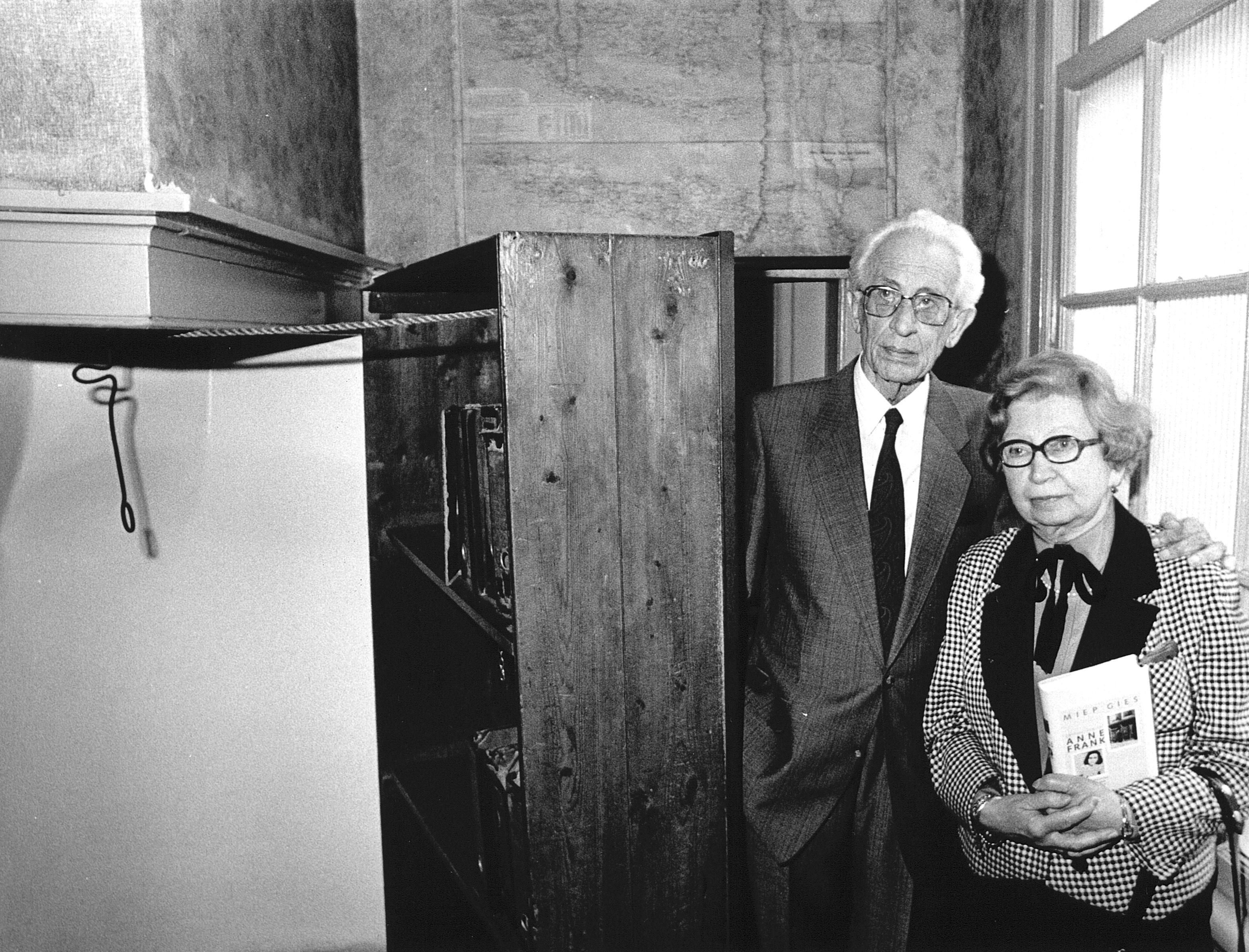 Miep and Jan Gies, years later, stand by the bookcase that hid a secret entrance to the hiding place of Anne Frank, her family and four others in Nazi-occupied Amsterdam