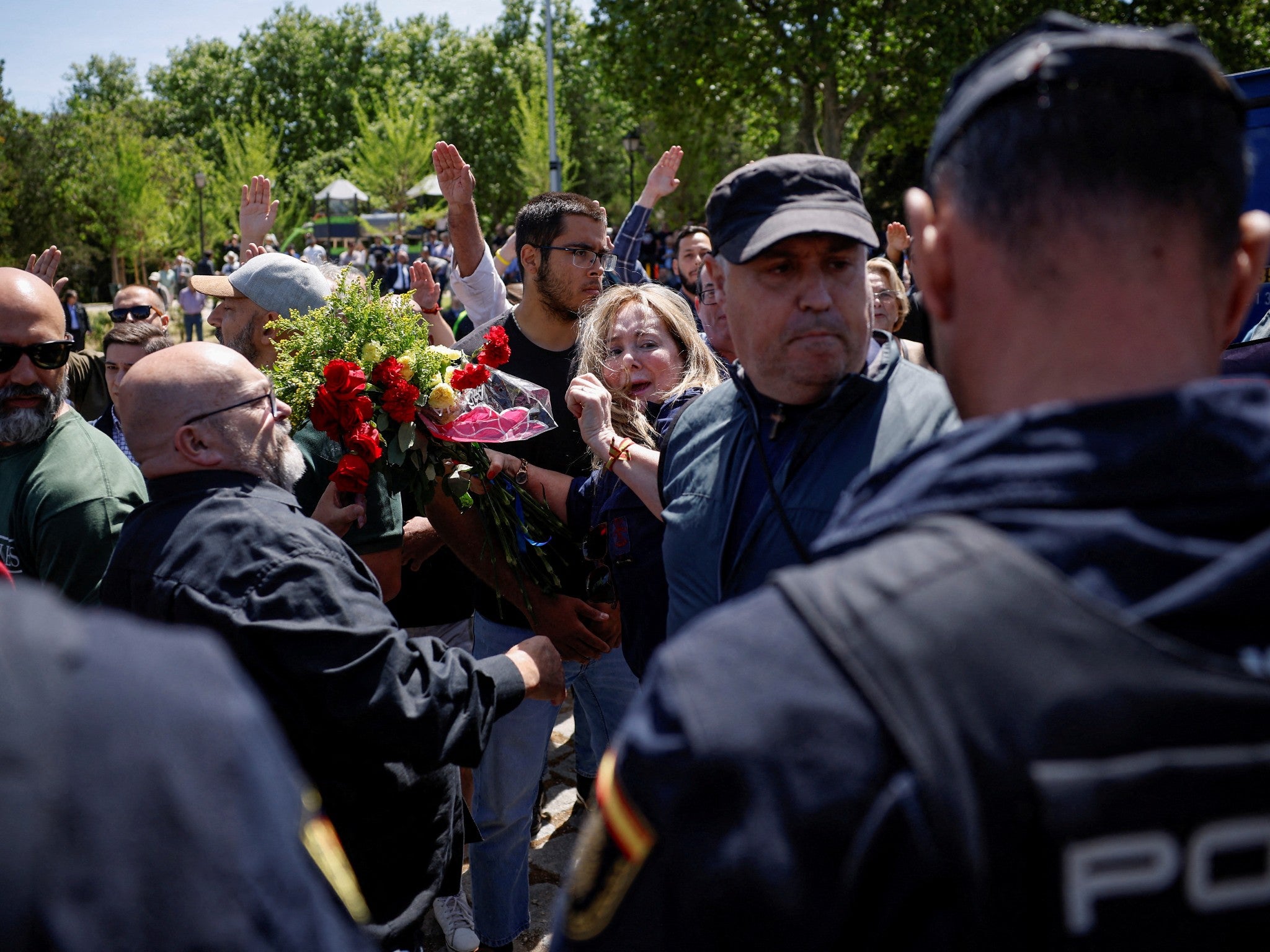 Supporters of the founder of Spanish fascist Falange party, Jose Antonio Primo de Rivera, scuffle with police officers outside the San Isidro cemetery