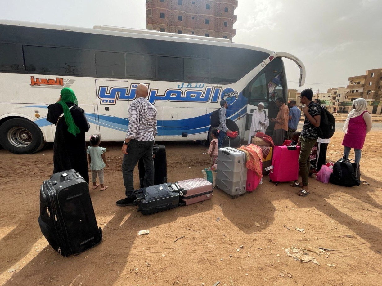 People gather as they flee clashes between the paramilitary Rapid Support Forces and the army in Khartoum