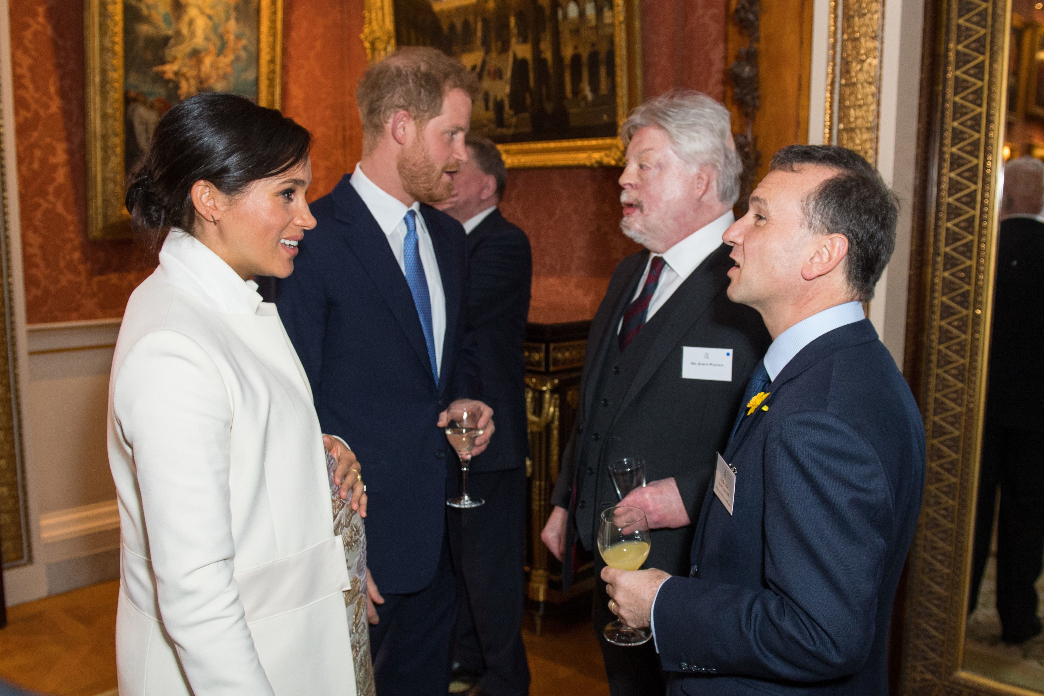 The Duke and Duchess of Sussex meet Simon Weston and Welsh secretary Alun Cairns during a reception at Buckingham Palace in London