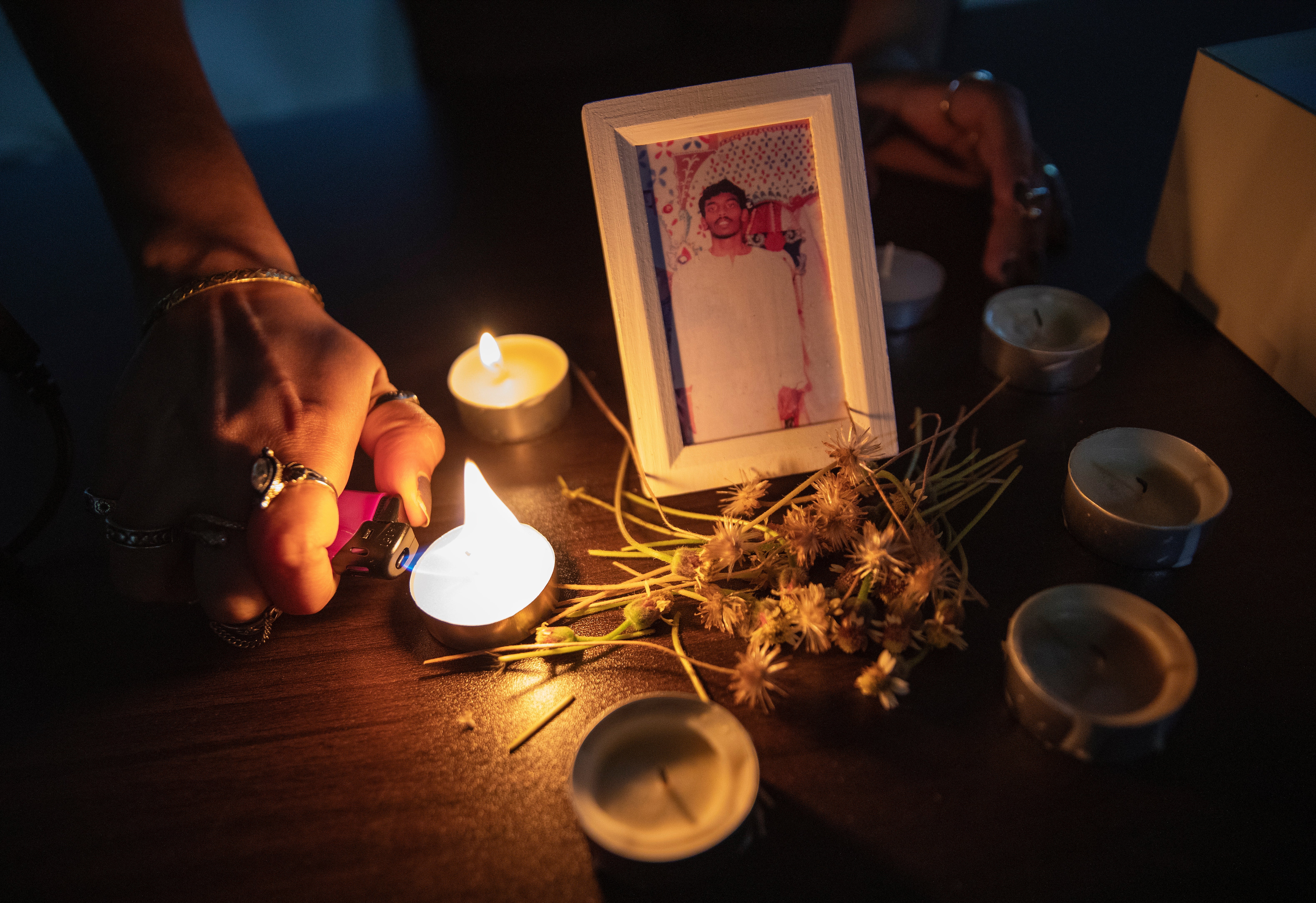 An activist lights candles for death row inmate Tangaraju Suppiah during a vigil for him at a private office in Singapore on 26 April