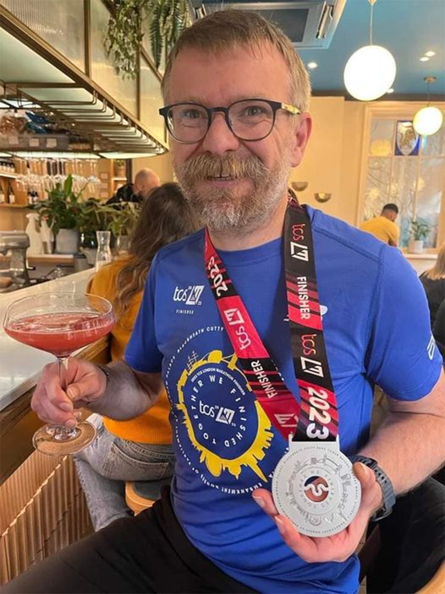 Shanks celebrating with a drink after finishing the marathon