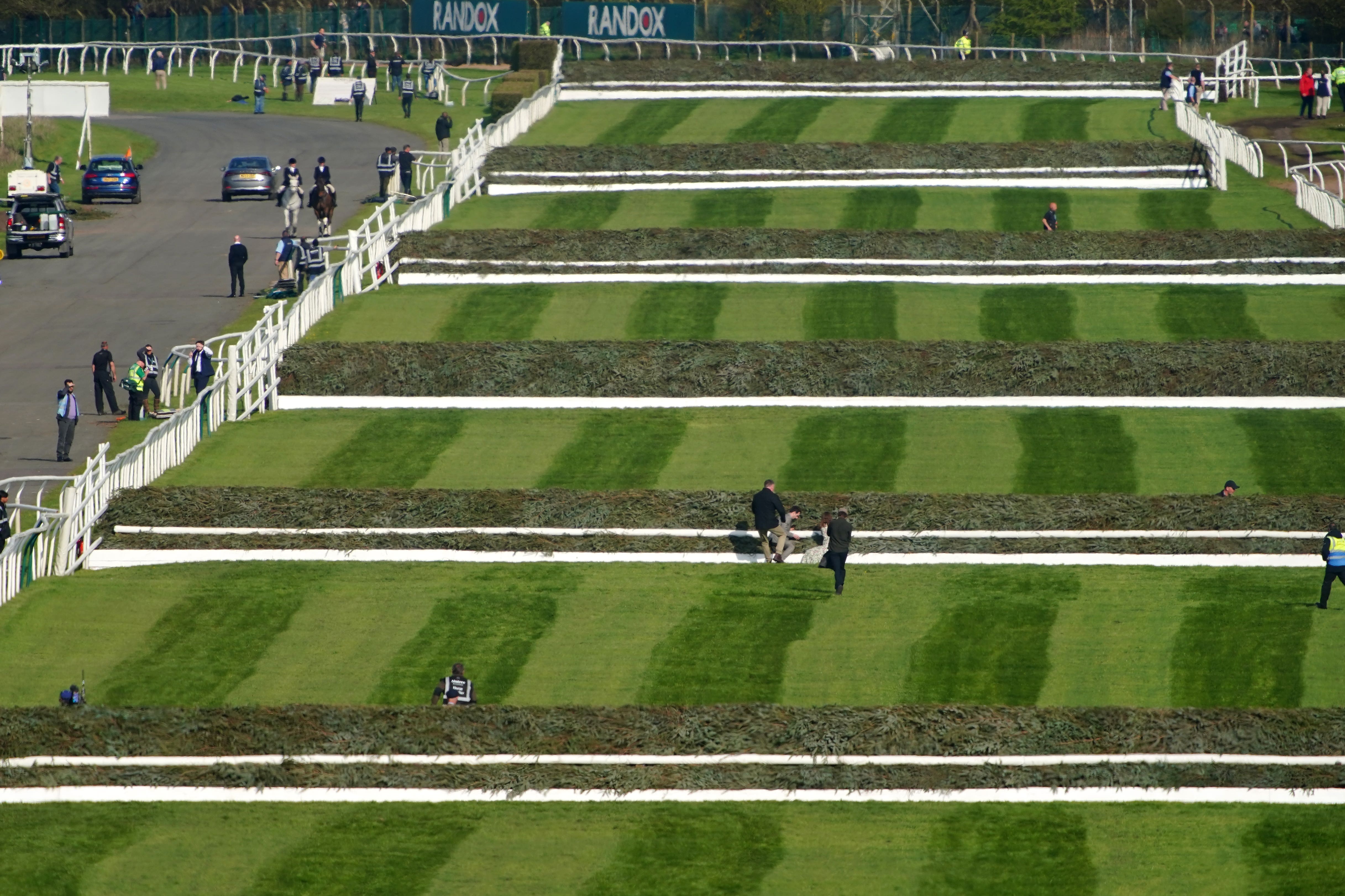 Animal Rising activists attempting to invade the race course ahead of the Randox Grand National Handicap Chase 23.(Peter Byrne/PA)