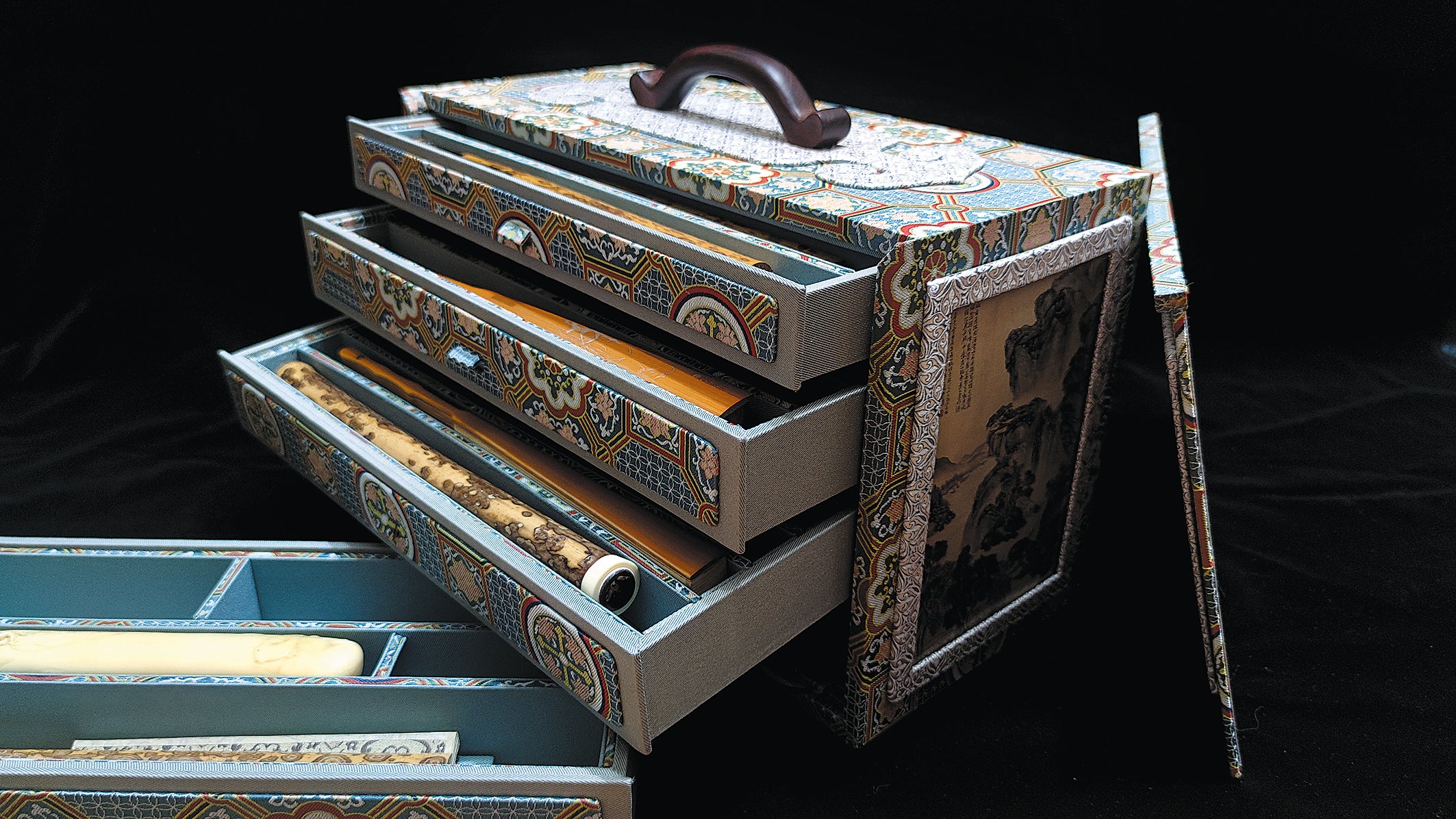 A suitcase containing traditional Chinese painting scrolls made by Gao