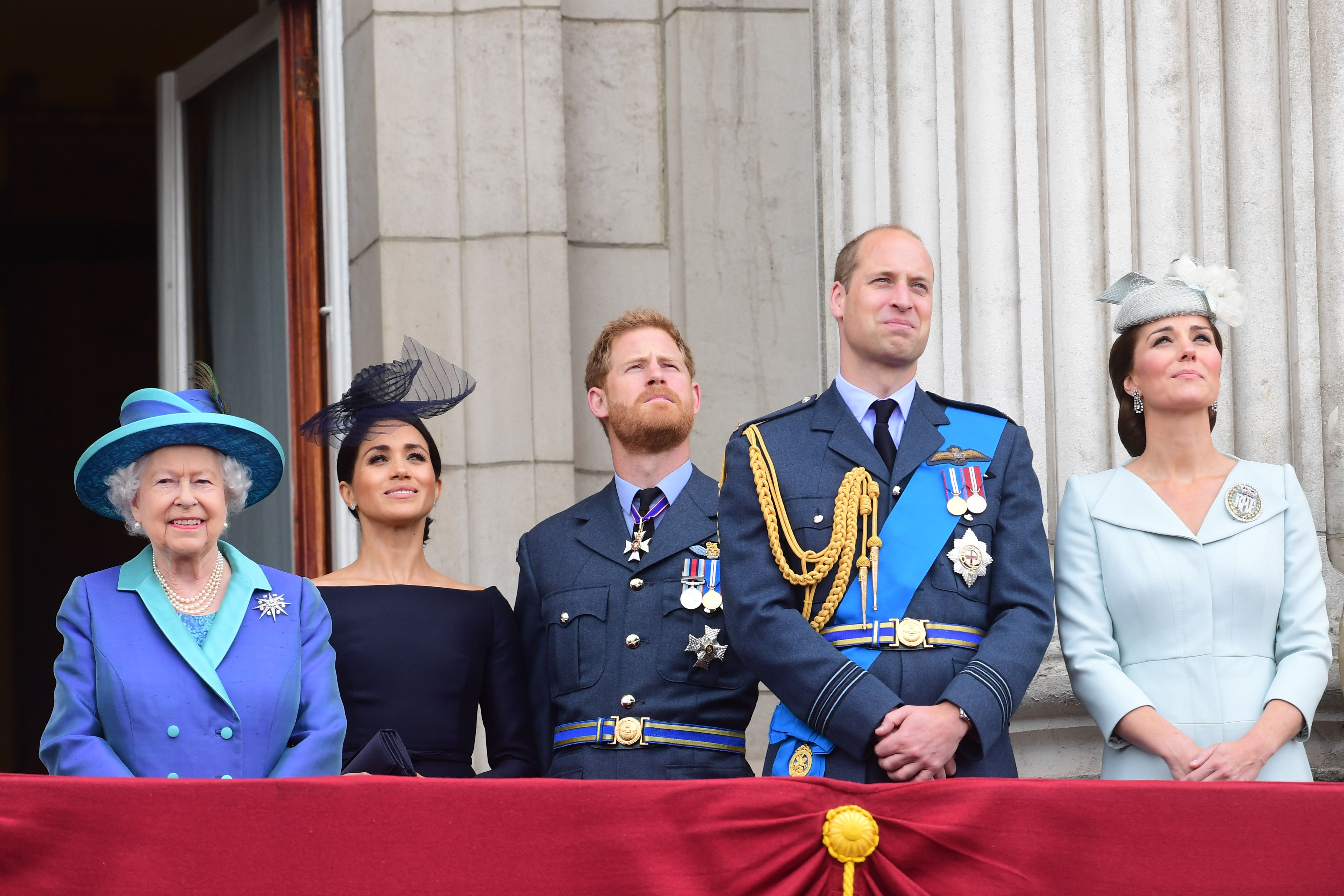 Queen Elizabeth II, Meghan Markle, Prince Harry, Prince William and Kate Middleton watch the RAF 100th anniversary flypast from the balcony of Buckingham Palace in July 2018