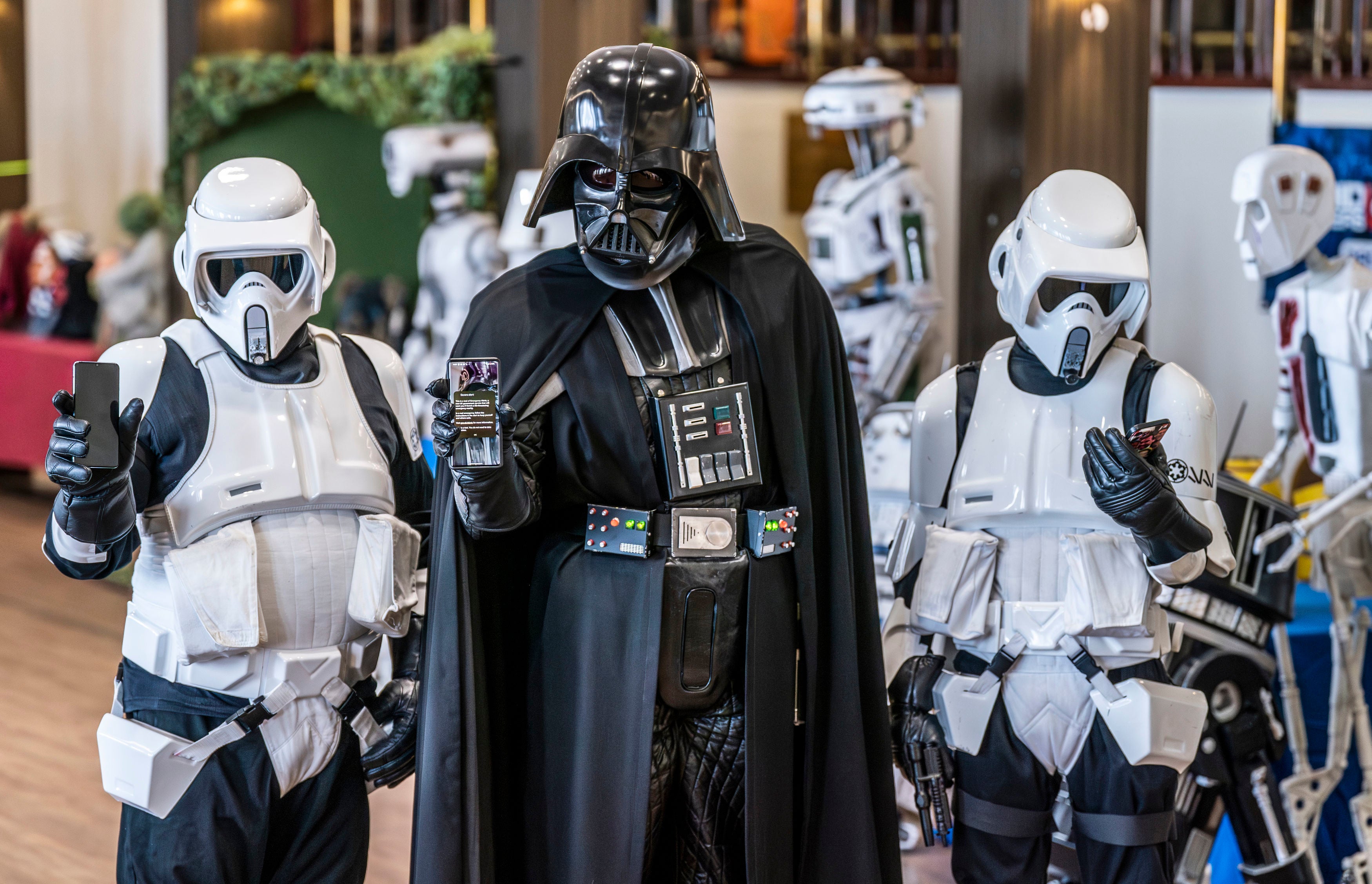 Members of the Sentinel Squad UK dressed as Darth Vader and Stormtroopers with their mobile phones during a test of a new emergency public alert system during the Sci Fi Scarborough at The Spa Complex in Scarborough