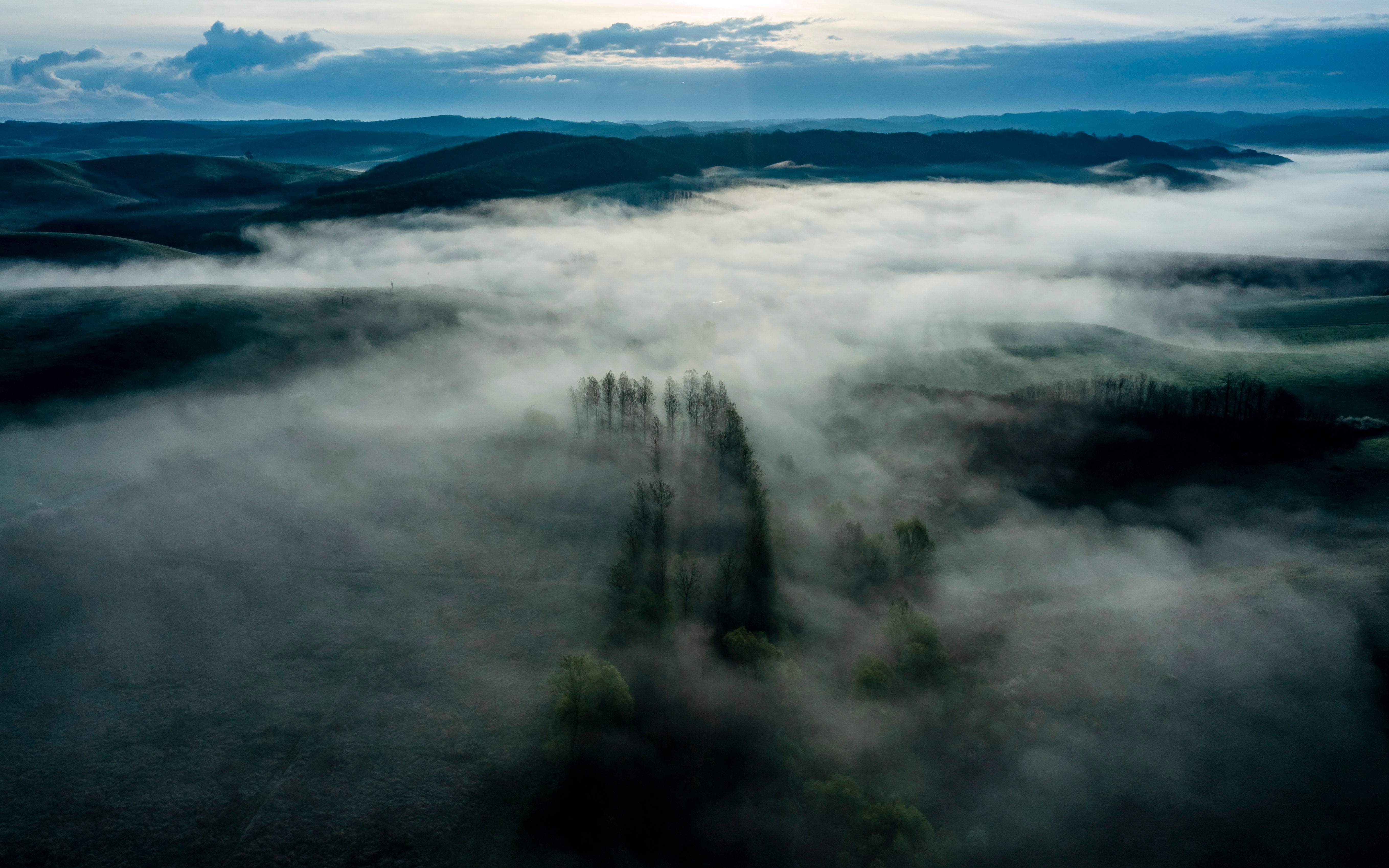 An aerial view taken by a drone shows morning mist lingering above the landscape near the munincipality of Cered, northern Hungary