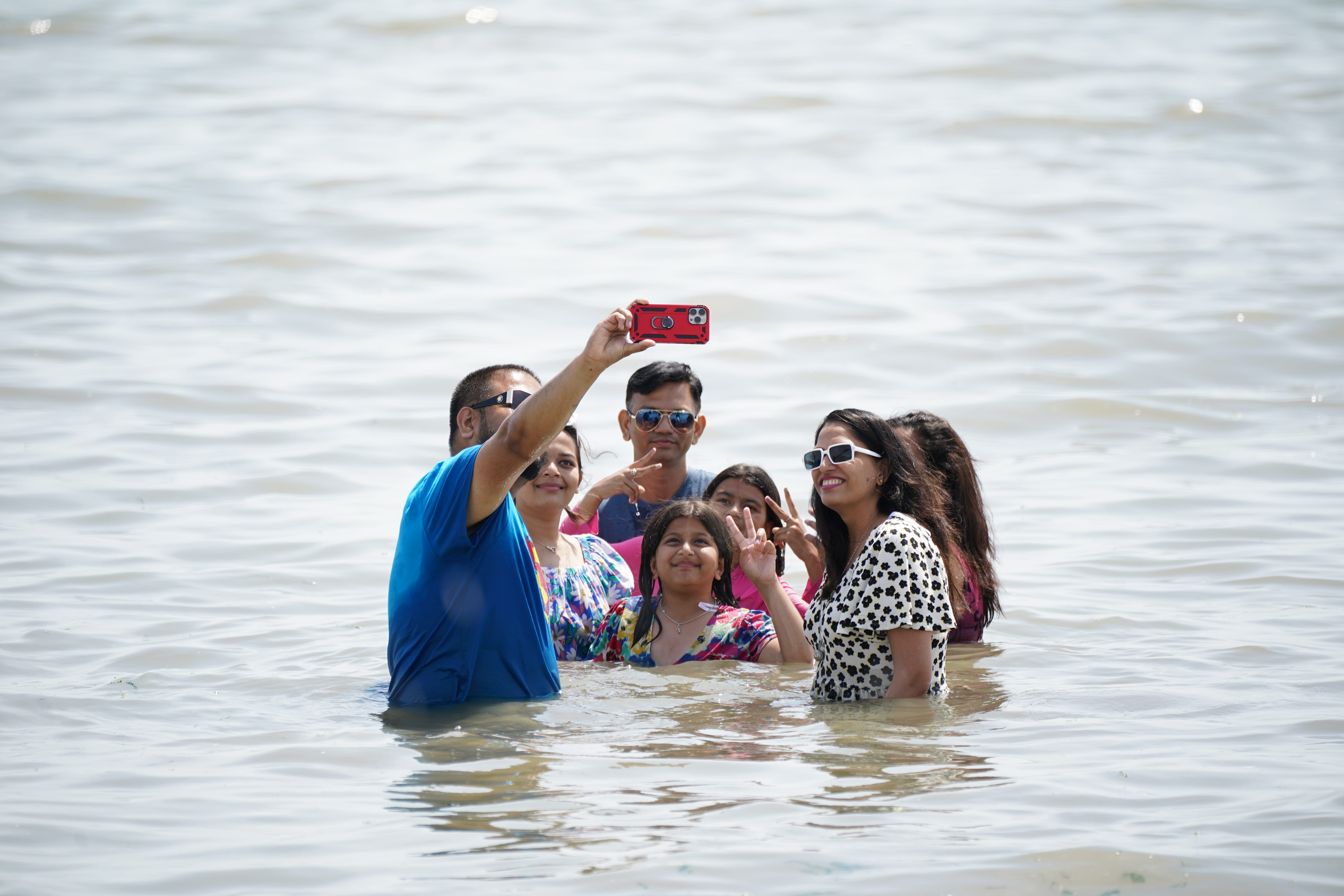 Researchers said the findings indicate people who opt to depict themselves in the scene by taking selfies do so to capture the deeper meaning of the event (Yui Mok/PA)