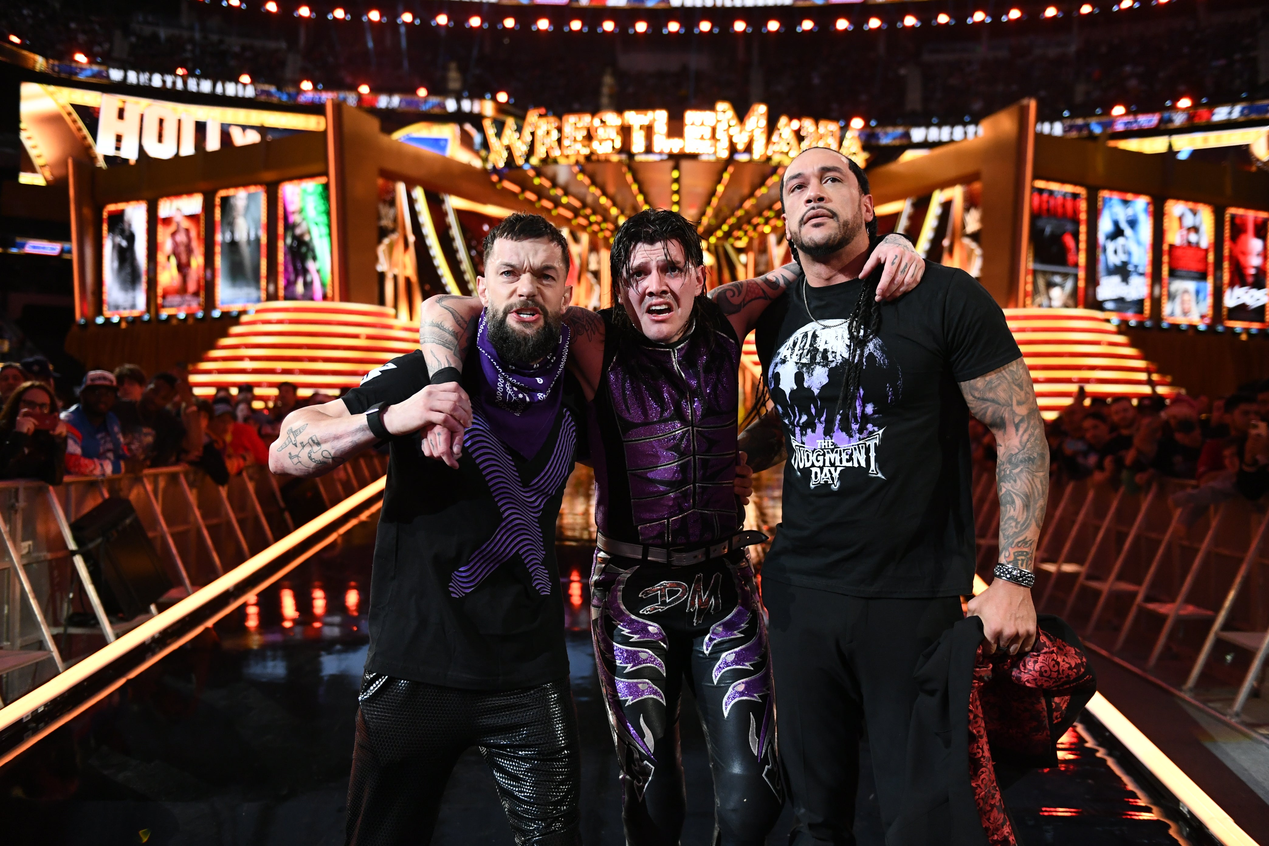 Mysterio with teammates Finn Balor (left) and Damian Priest