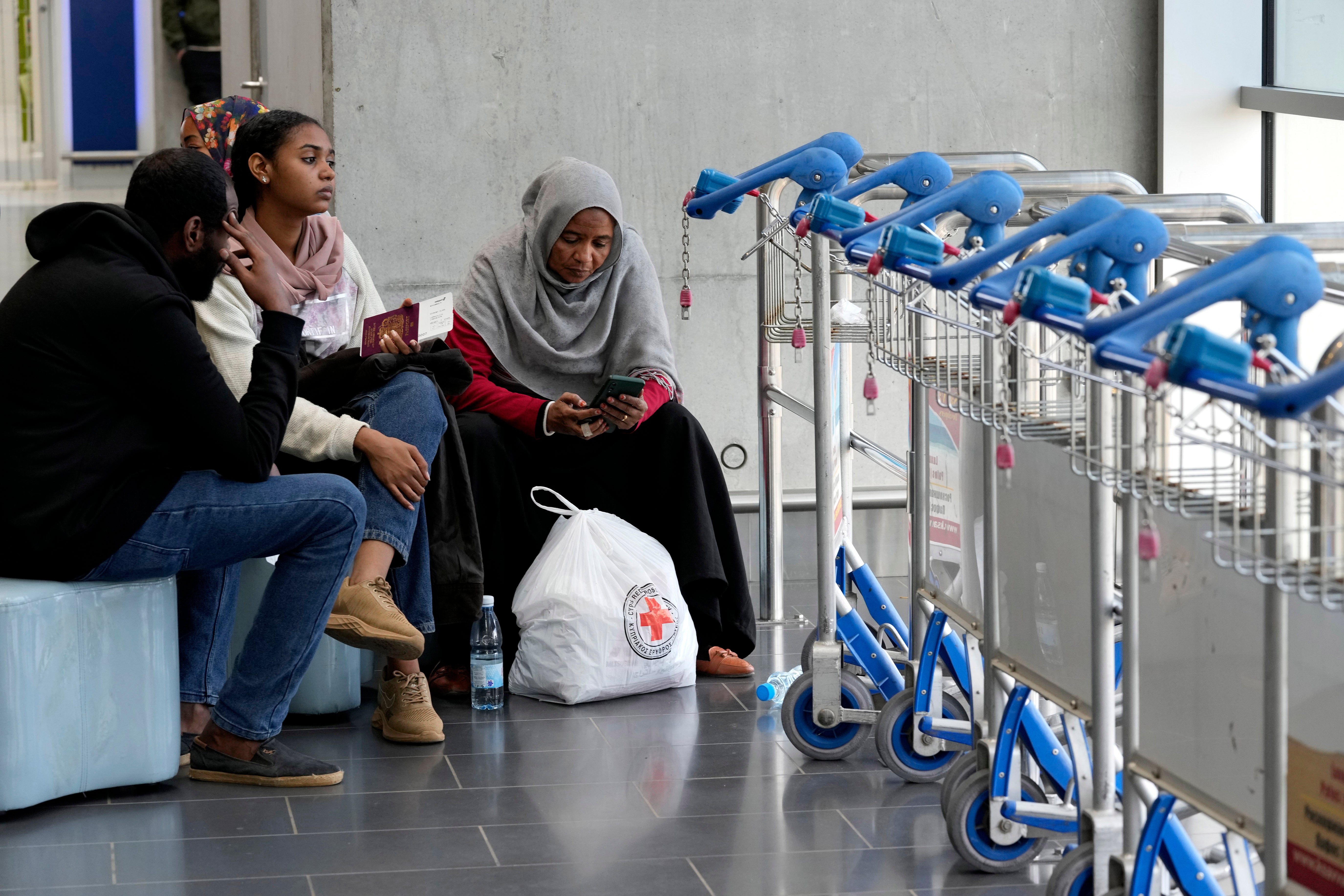 Evacuees from Sudan wait for their flight at Larnaca airport, Cyprus, where the retired doctor has arrived safely with his daughter and his 87-year-old mother