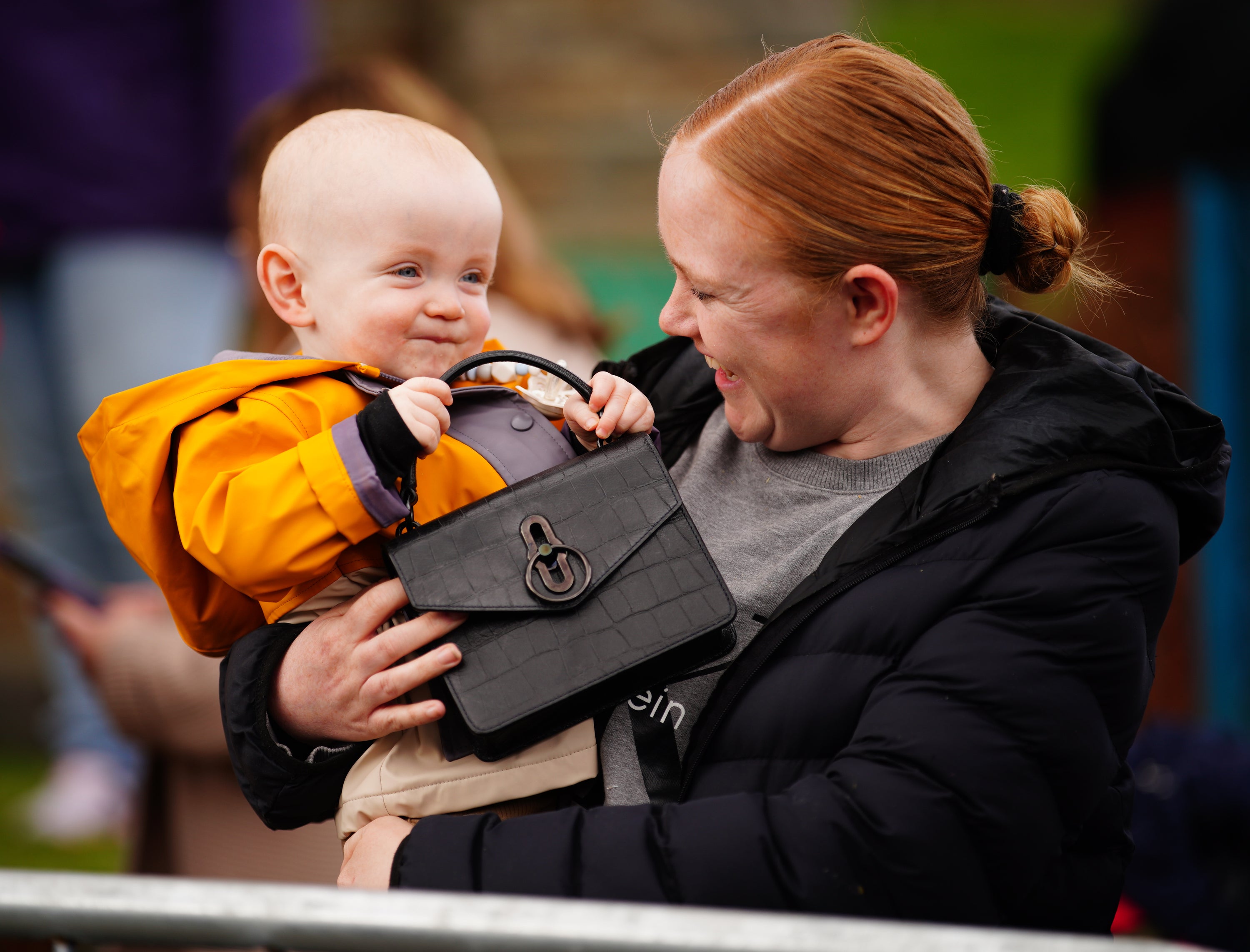 Lucy Williams holds her son Daniel as he plays with the Princess of Wales’s handbag