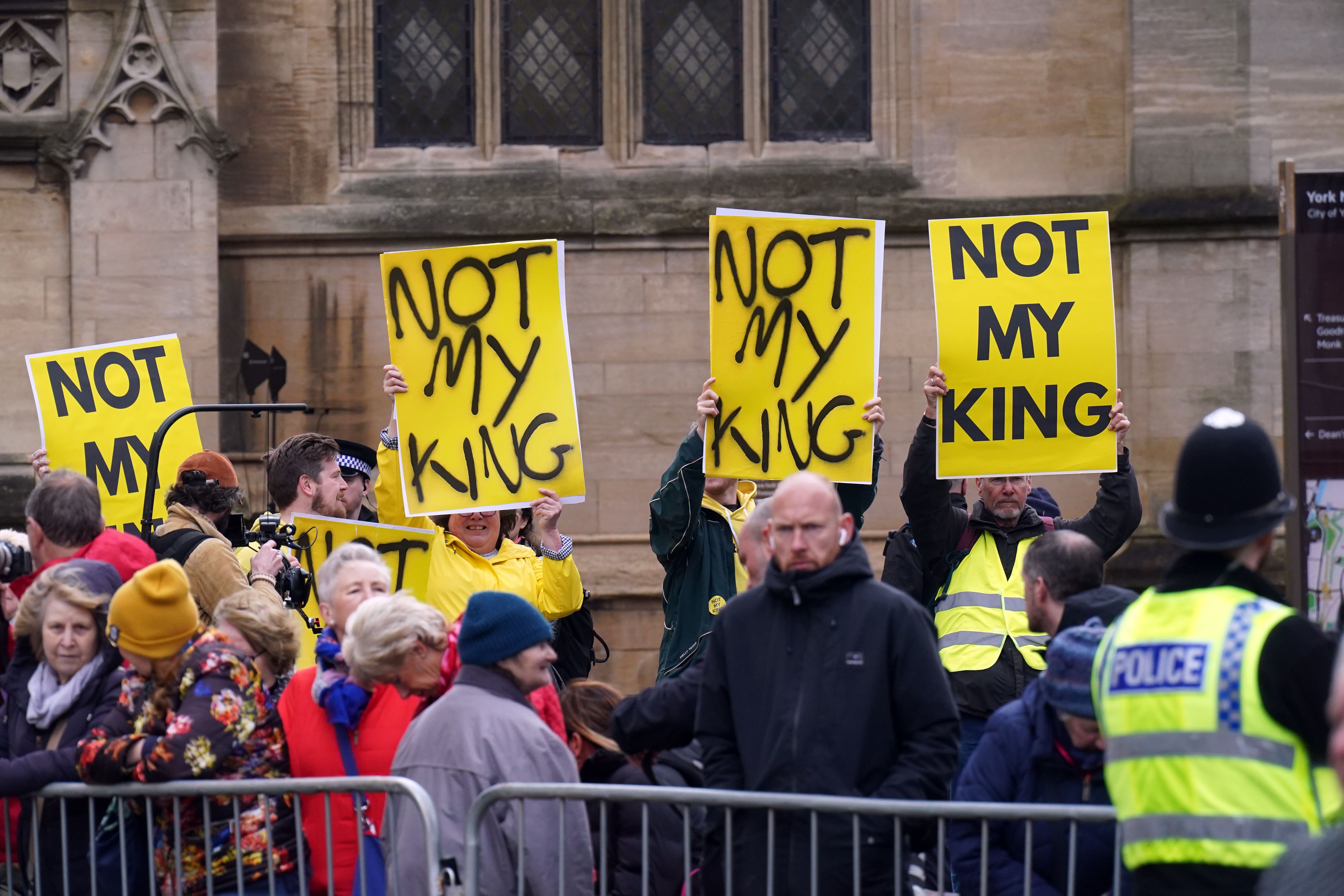 Protesters await the arrival of the King in York (PA)