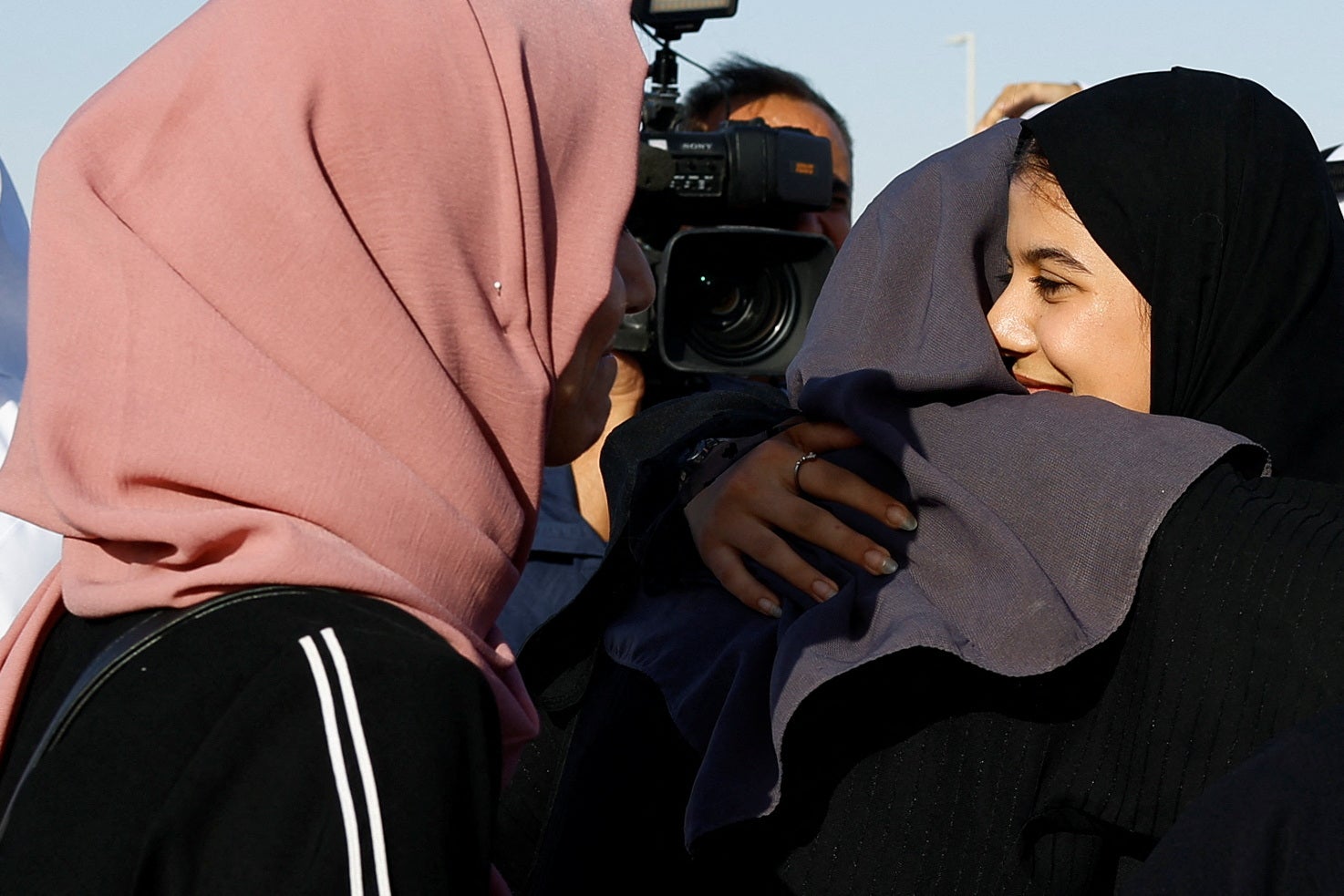 Yamama Hasani Alhussein, who was evacuated from Sudan to escape the conflict, is greeted as she arrives at Abu Dhabi airport