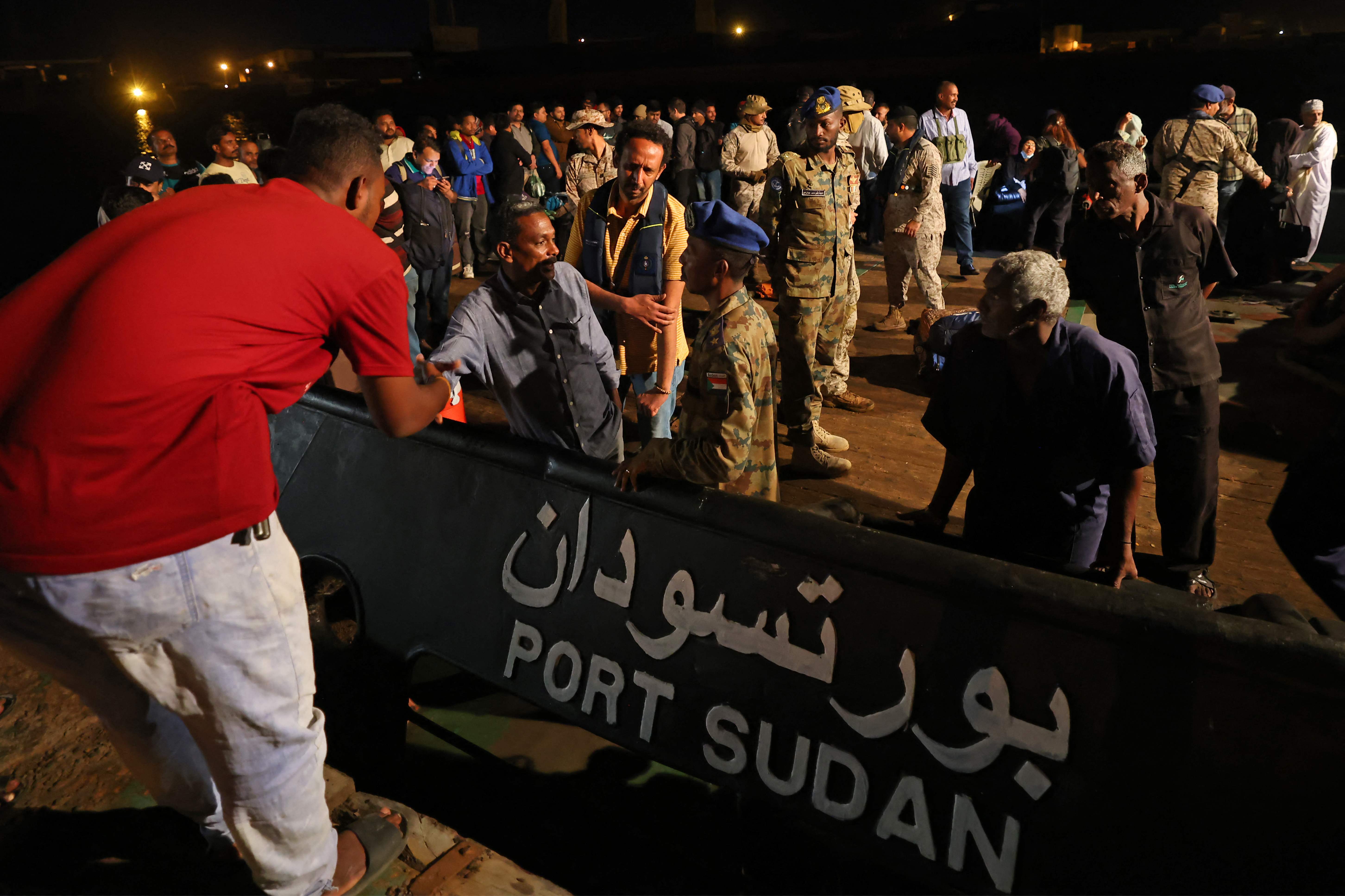 Evacuees board a tugboat at Port Sudan on April 30, 2023 during a rescue operation carried out by the Saudi navy