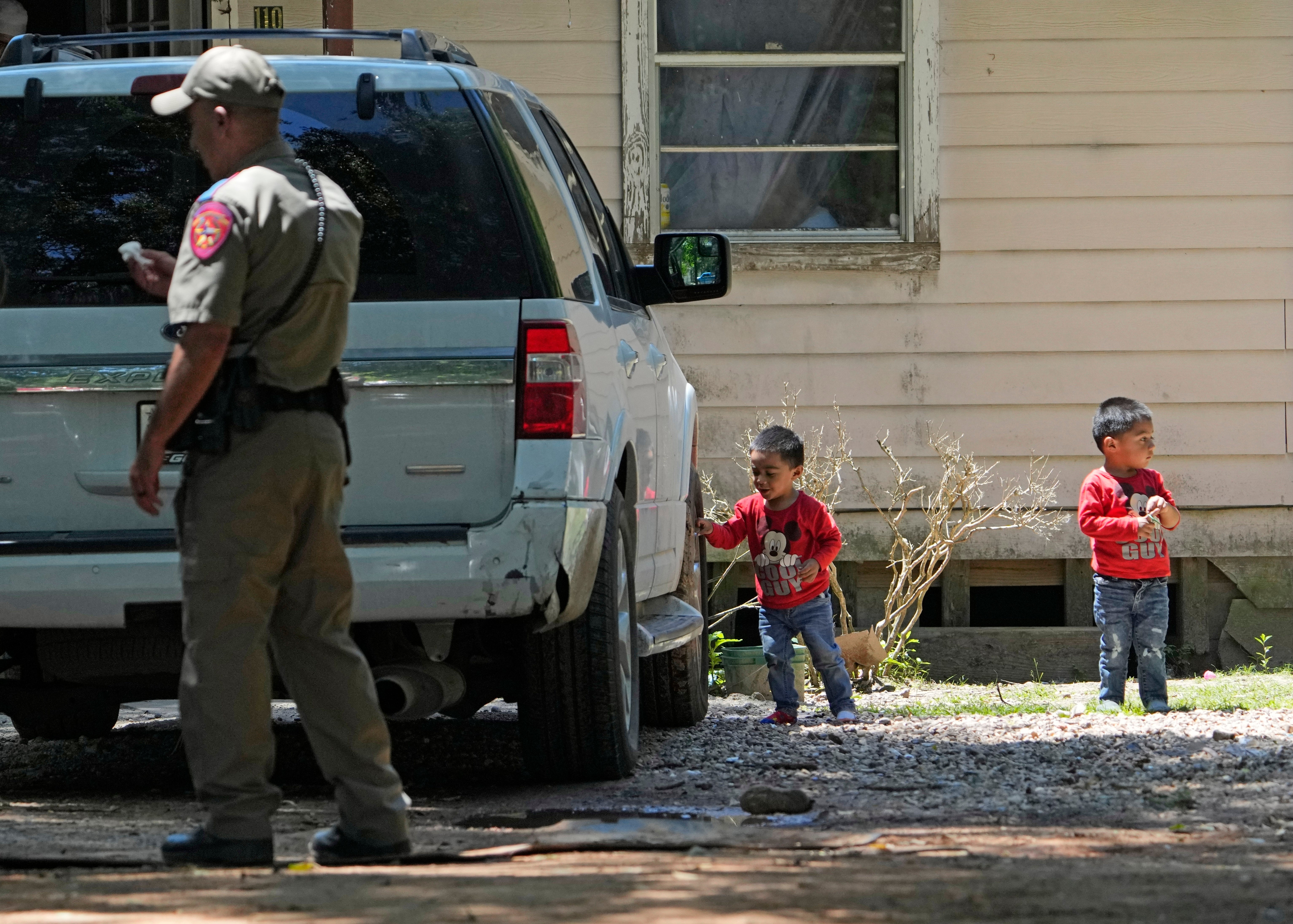 Children play outside the scene of the mass shooting in Cleveland