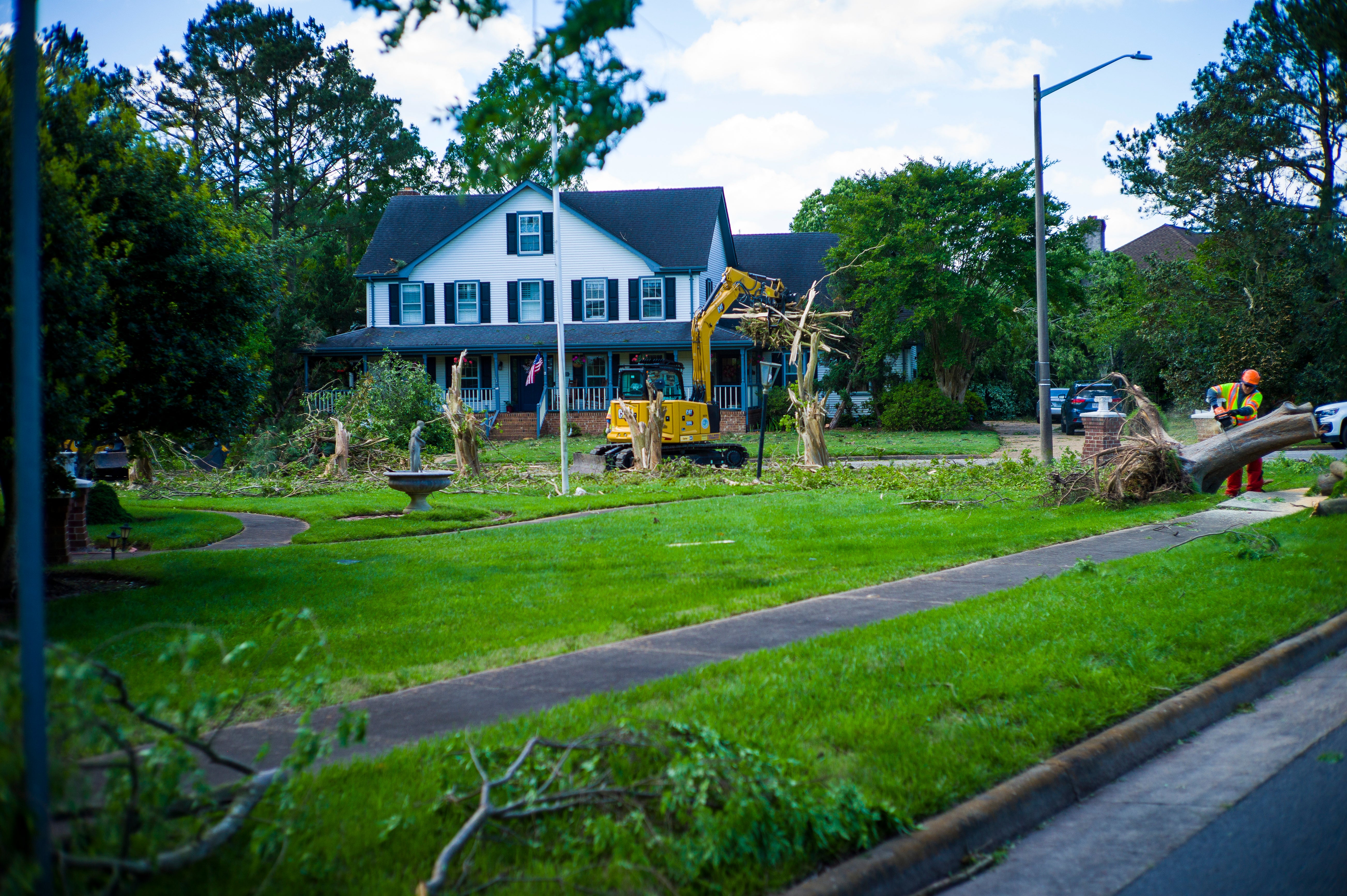 Damage from Sunday's EF-3 rated tornado is cleaned up in the Great Neck area of Virginia Beach, Va., on Monday May 1, 2023