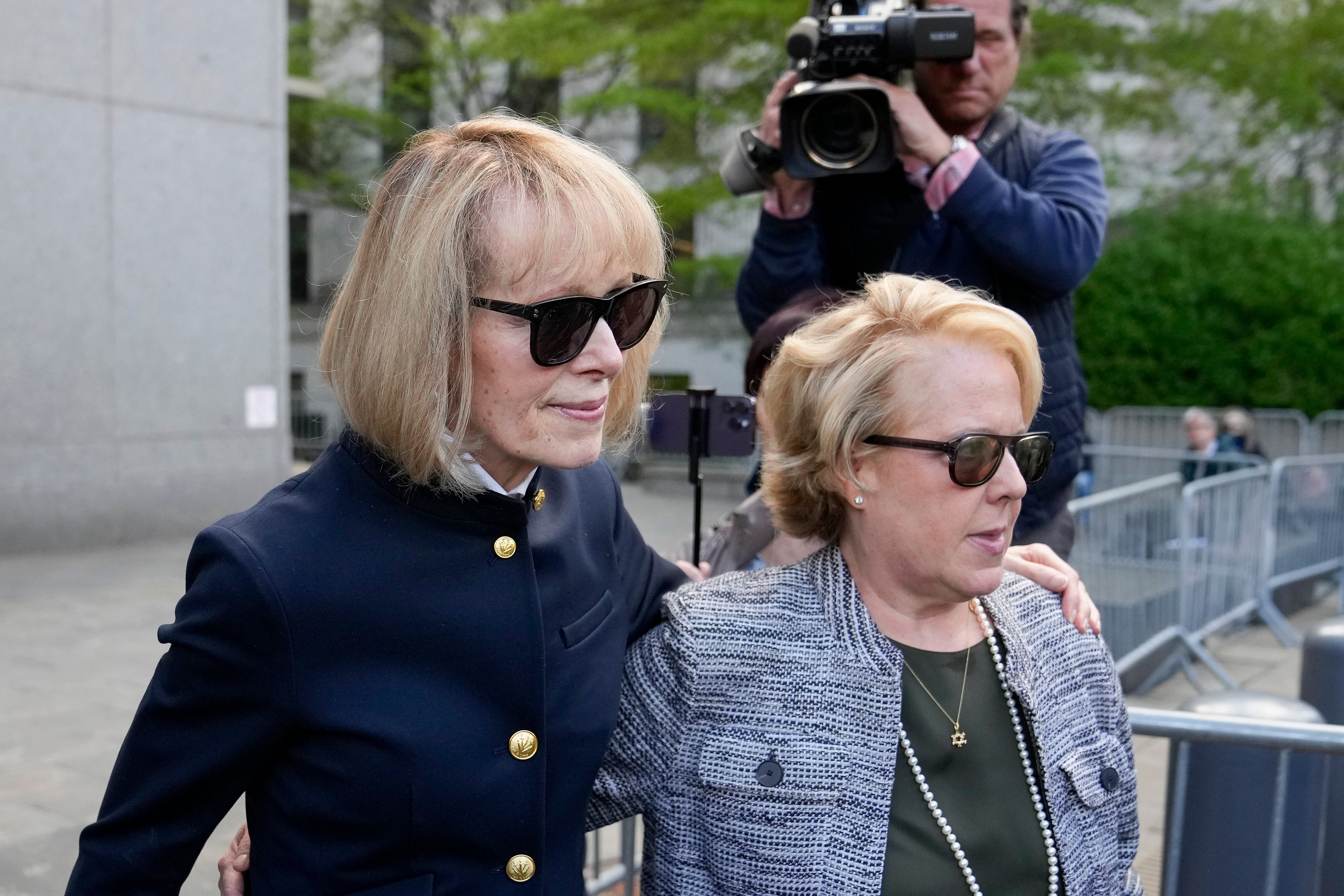 Former Elle advice columnist E Jean Carroll, left, departs Manhattan federal court, with her attorney Roberta Kaplan on Monday, May 1.