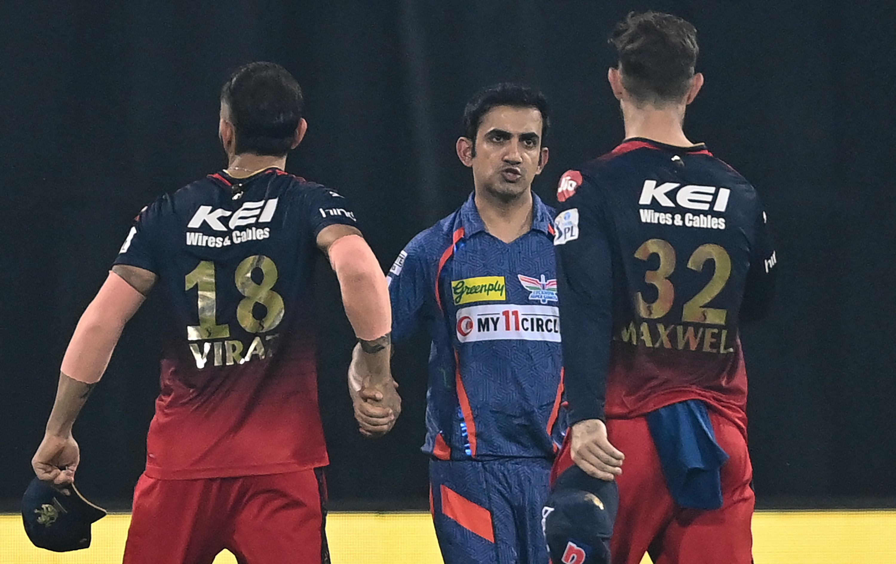 Lucknow Super Giants’ team mentor Gautam Gambhir (centre) shakes hands with Royal Challengers Bangalore’s Virat Kohli (left) and Glenn Maxwell (right) at the end of the Indian Premier League (IPL) Twenty20 cricket match between Lucknow Super Giants and Royal Challengers Bangalore