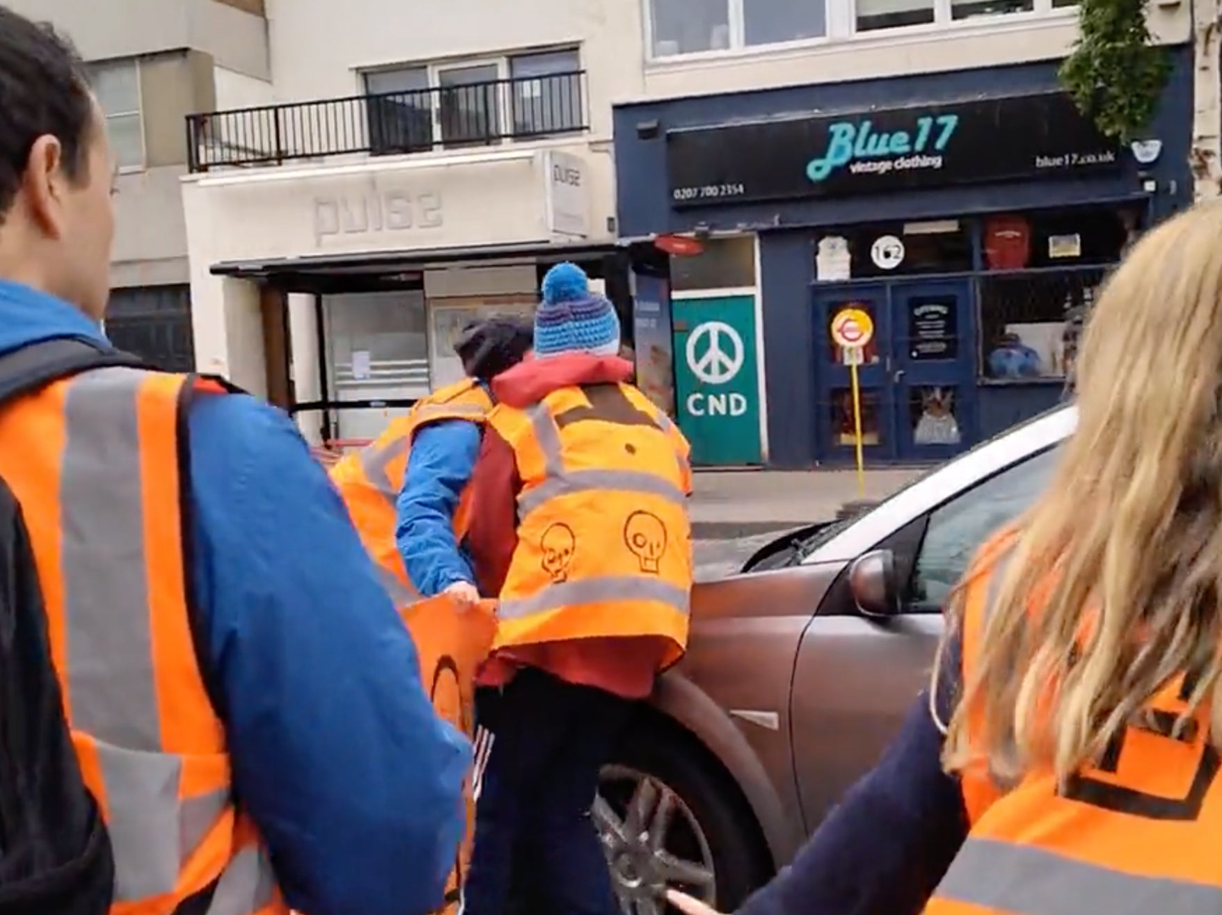 The vehicle appears to collide with the protestor, before continue to drive down the road