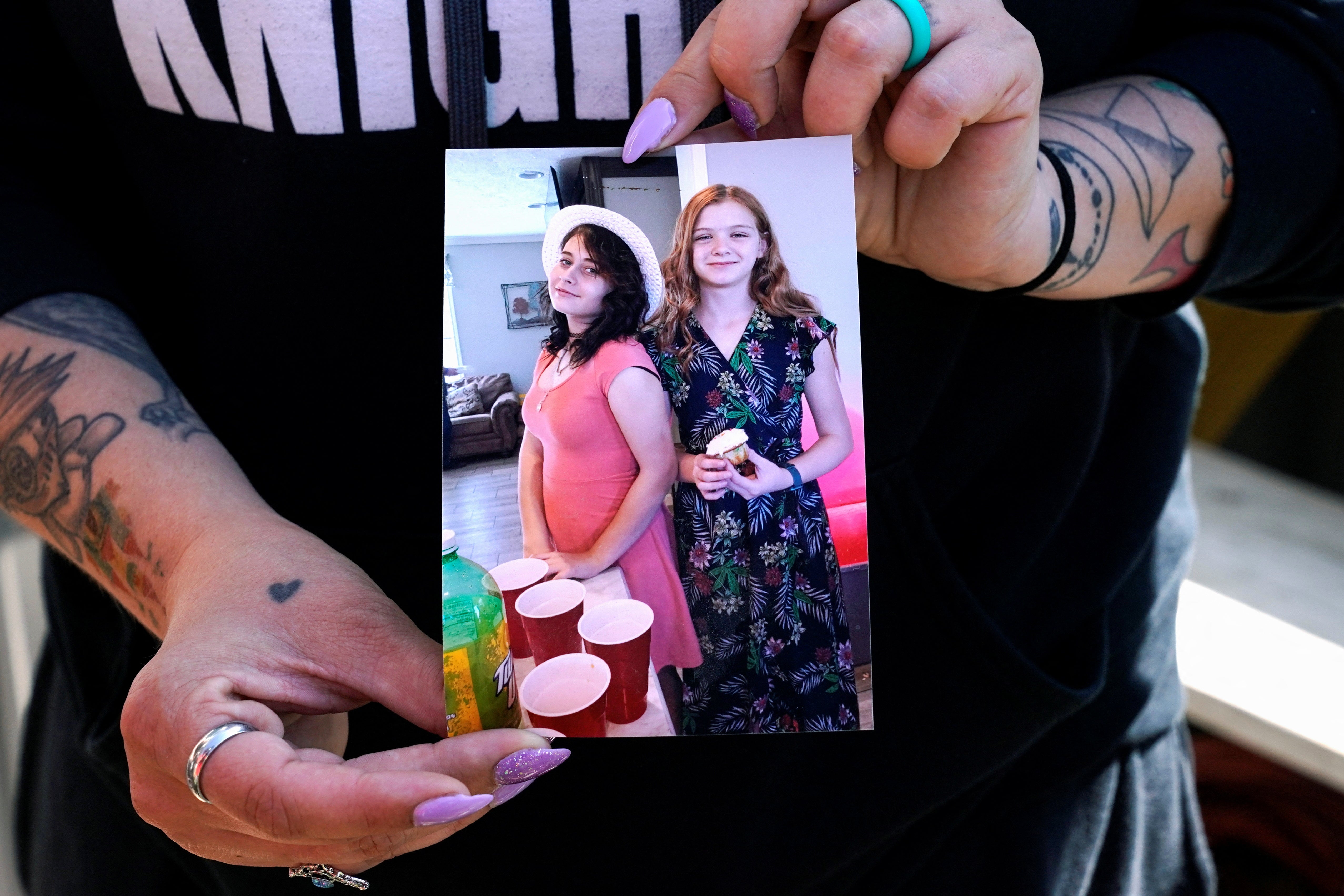 Ashley Webster shows a photo of her daughter Ivy Webster and her best friend Tiffany Guess, who were both murdered in Henryetta, Oklahoma, U.S. May 2, 2023