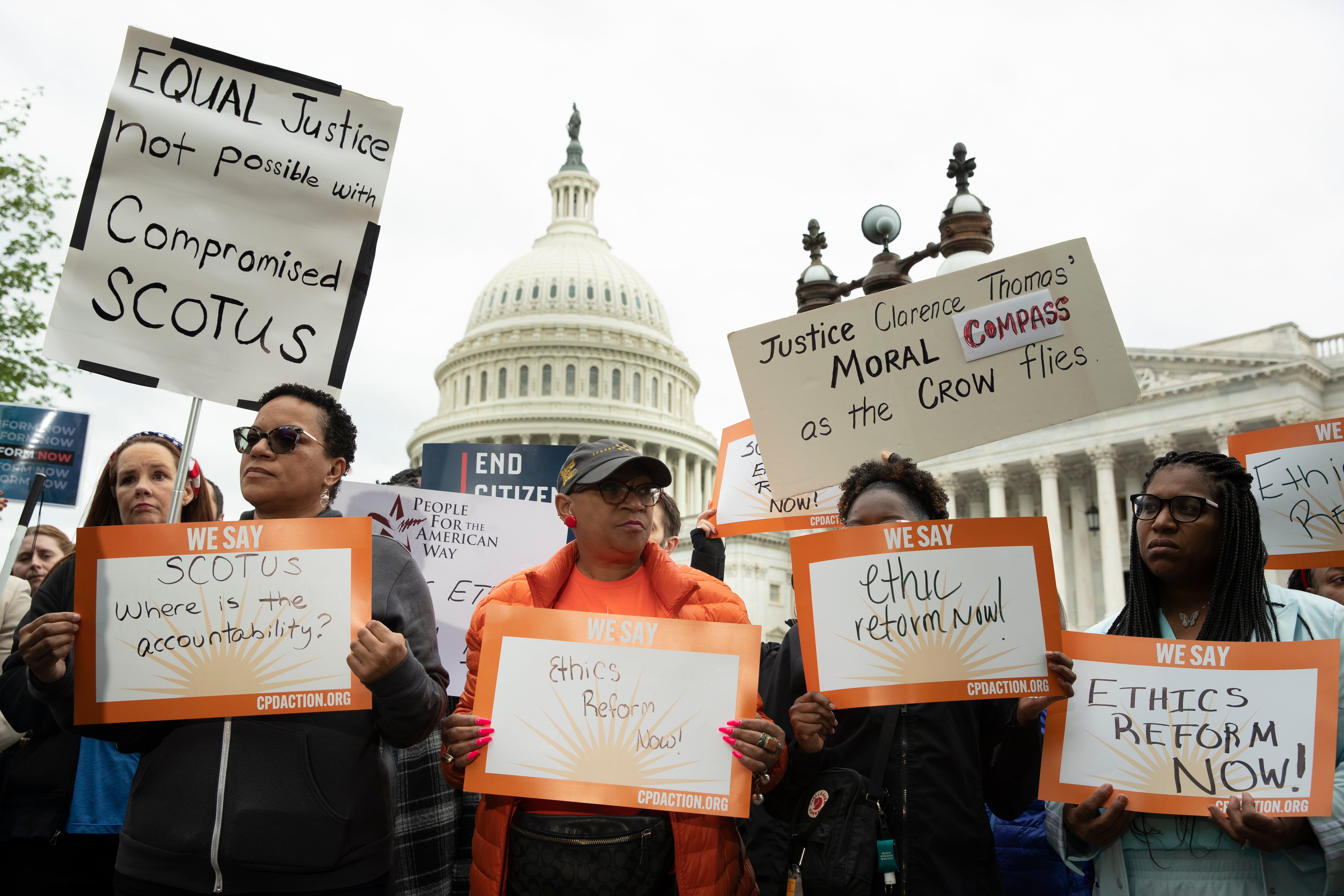 Activists attend a rally calling for an investigation into US Supreme Court Associate Justice Clarence Thomas, on Capitol Hill