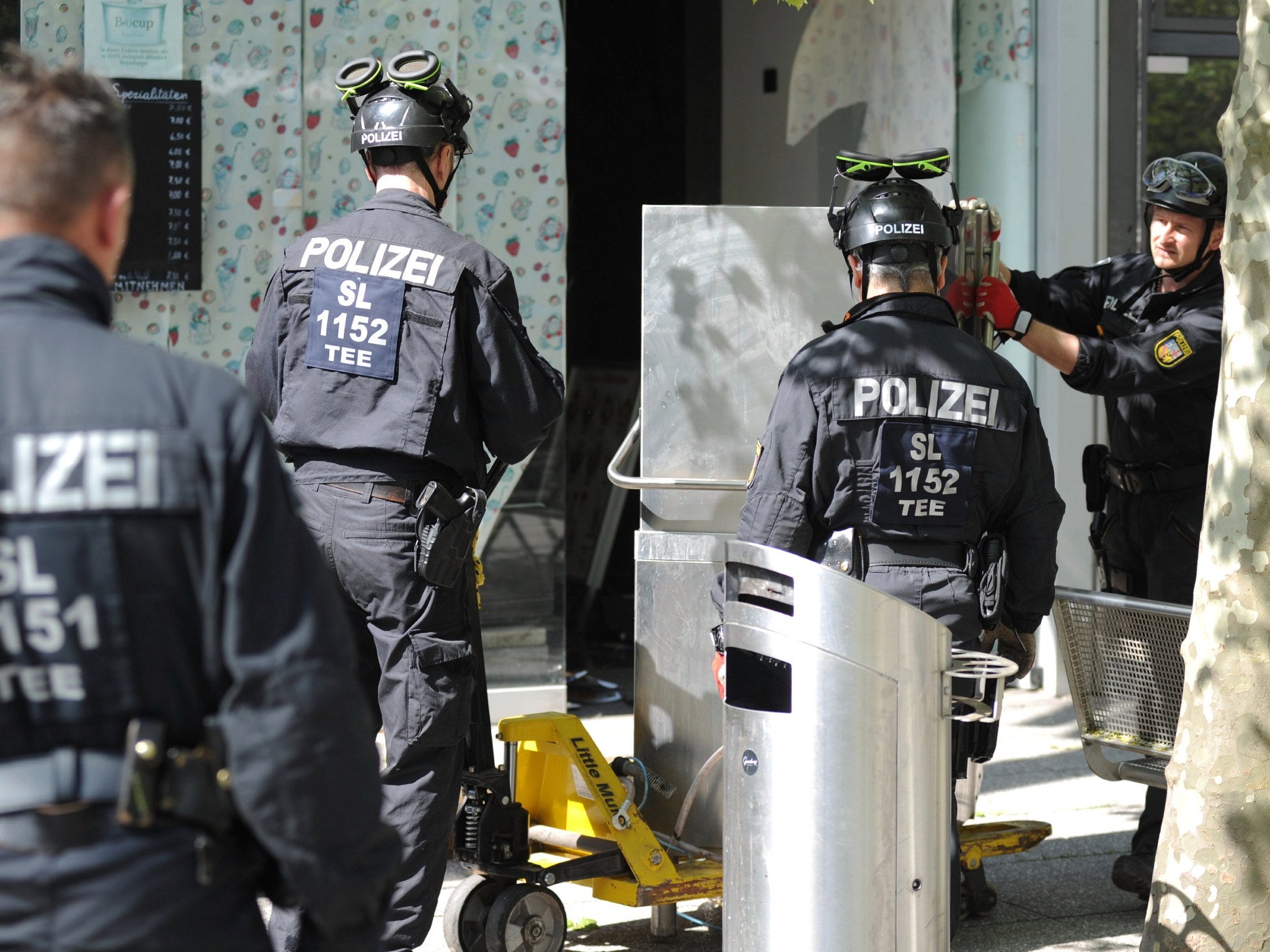 Police officers secure evidence during a raid in Saarlouis, Germany