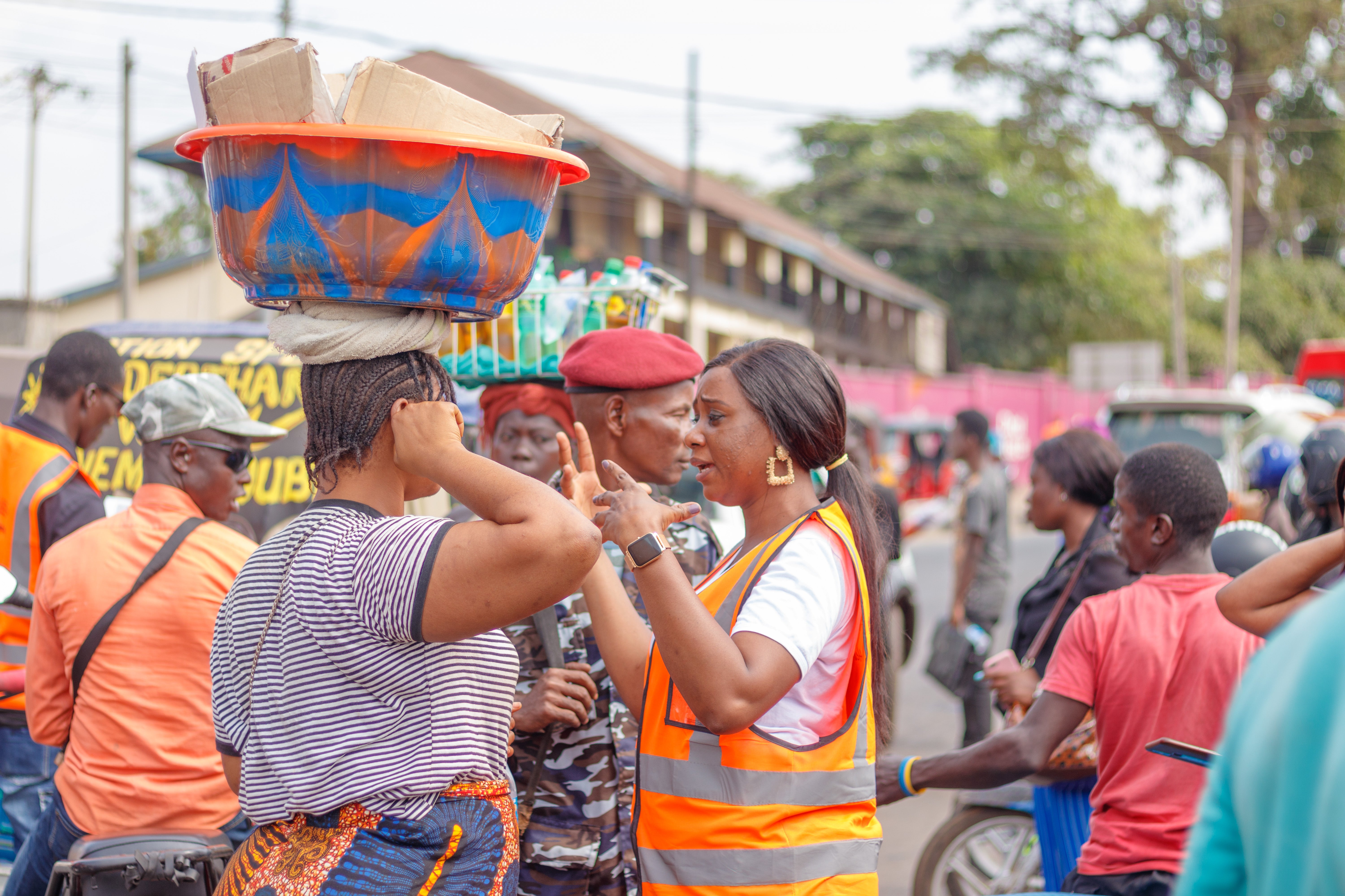 Eugenia Kargbo, the chief heat officer in Freetown, Sierra Leone, speaks with market traders