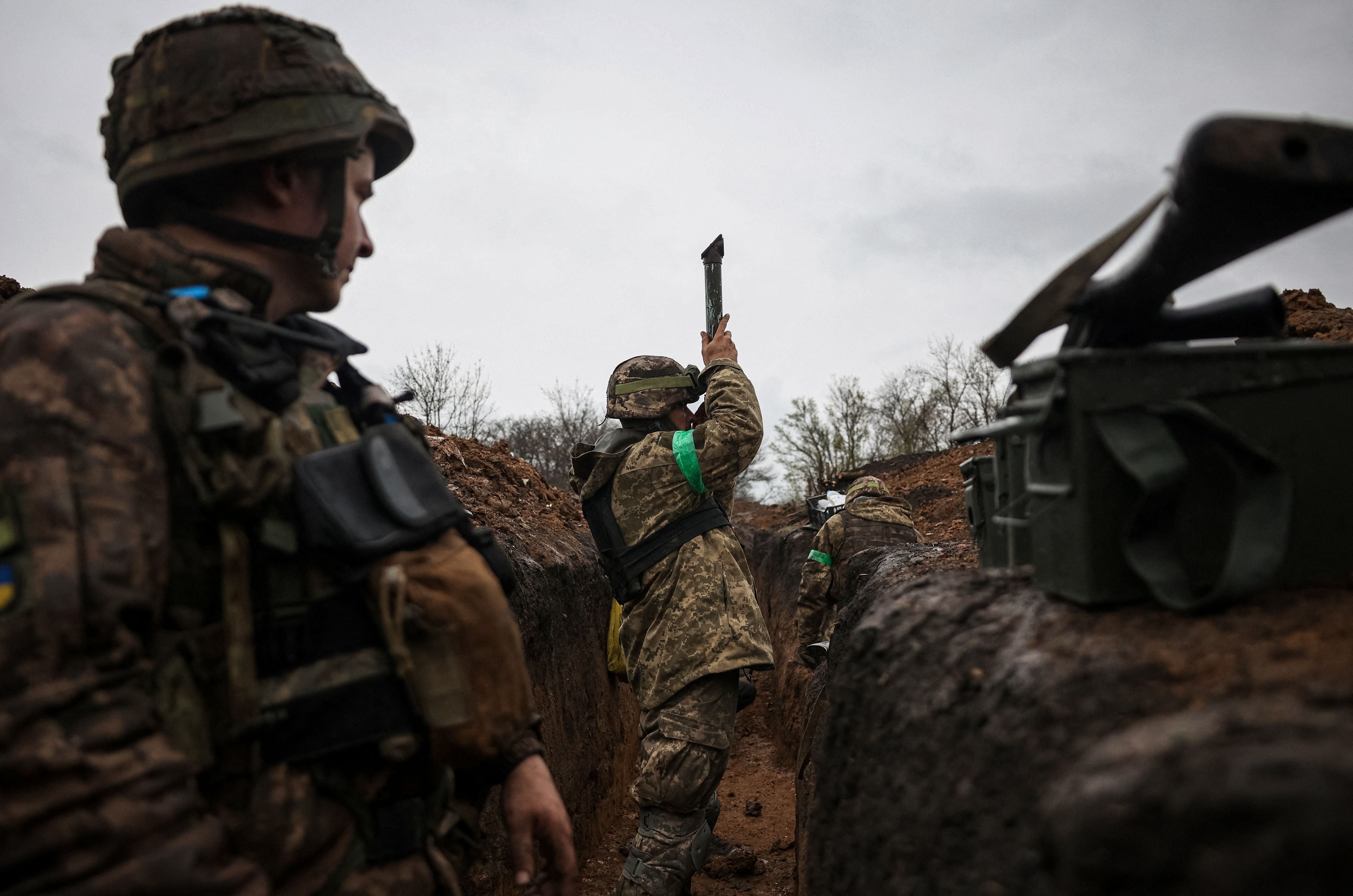 A Ukrainian infantryman of the 57th Separate Motorised Infantry Brigade, ‘Otaman Kost Khordienko’, uses a periscope in a trench near Bakhmut