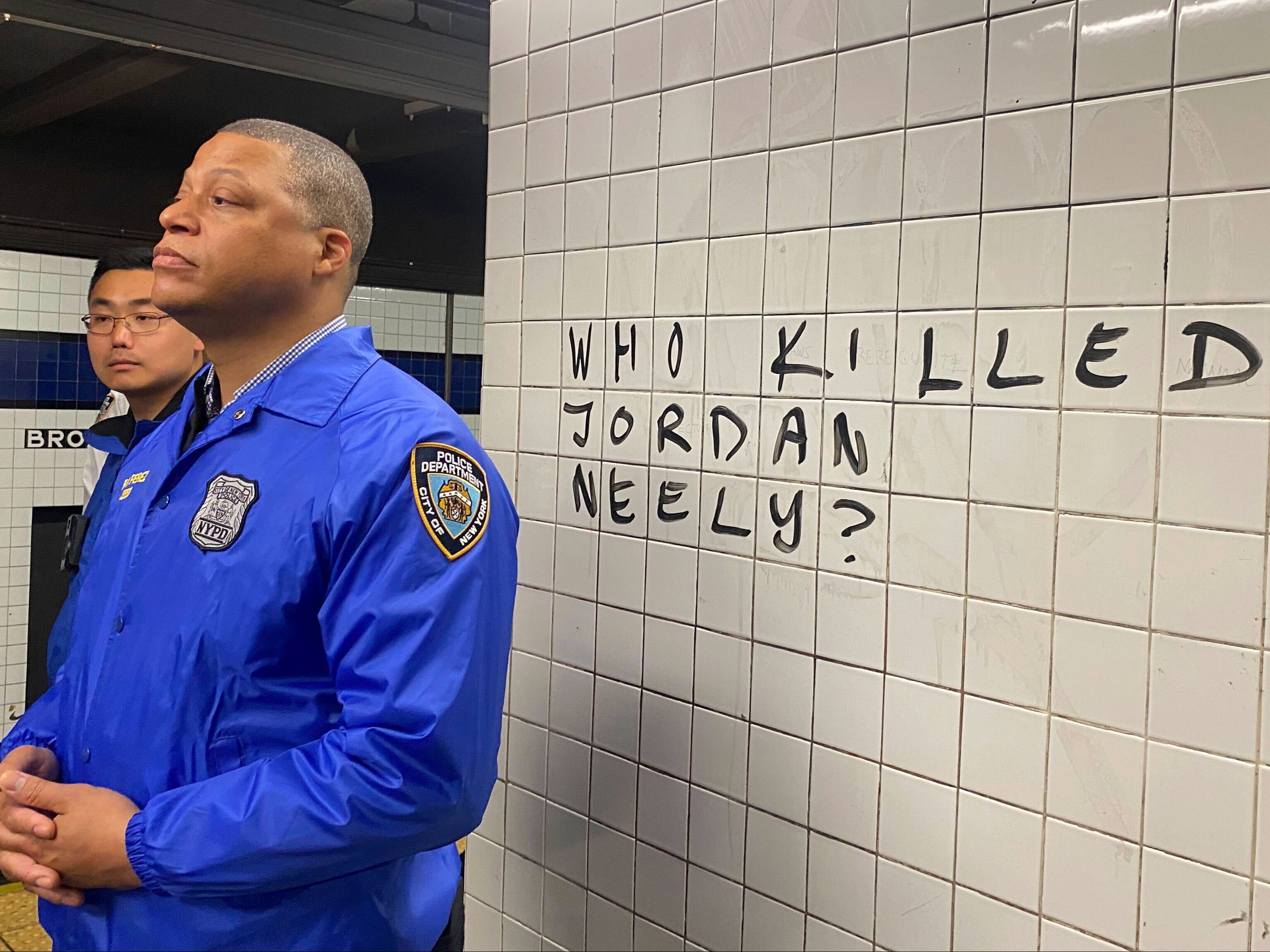 Police officers watch as protesters gather in the Broadway-Lafayette subway station in New York to protest the death of Jordan Neely