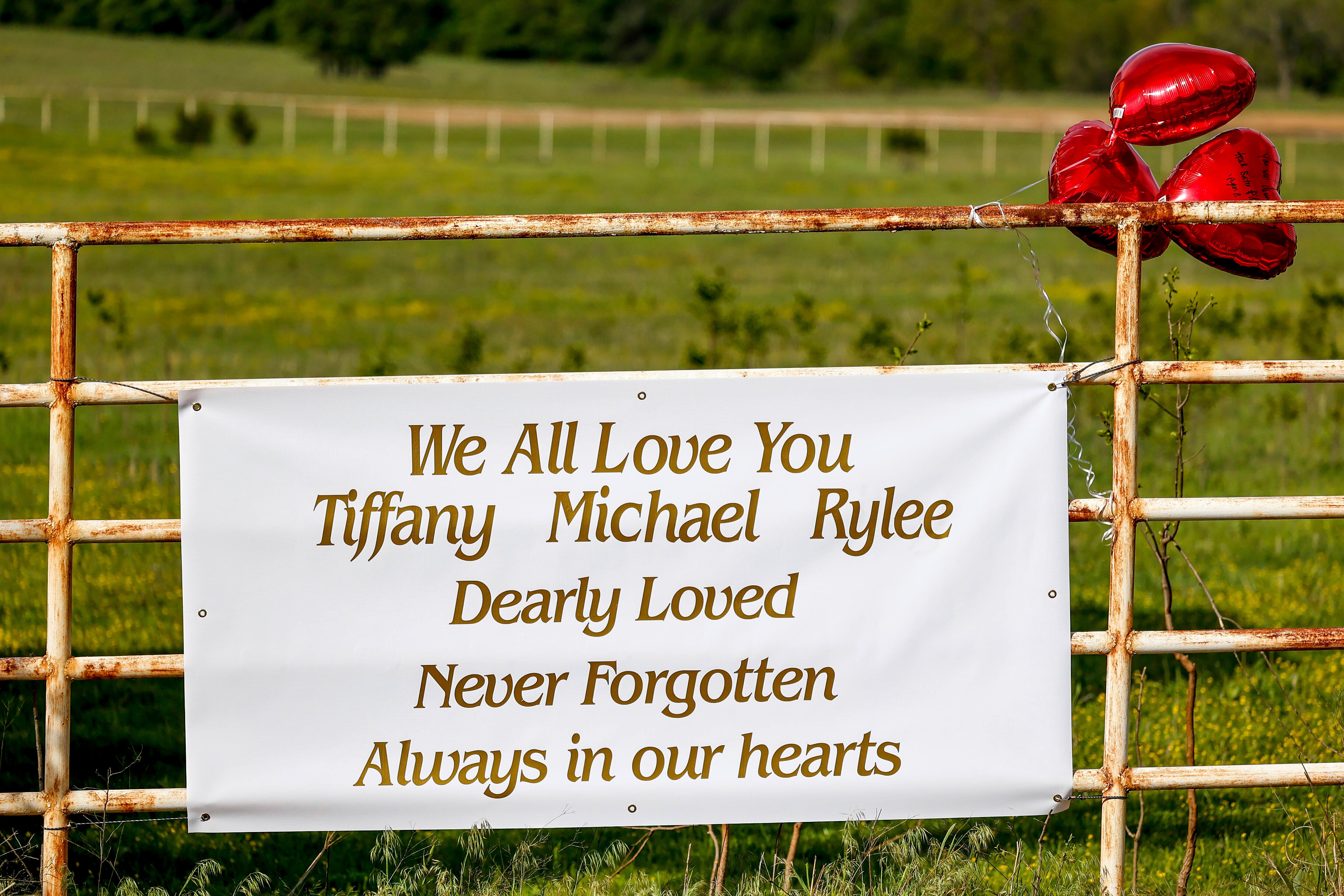 Memorial hanging on a gate close to where the bodies were found