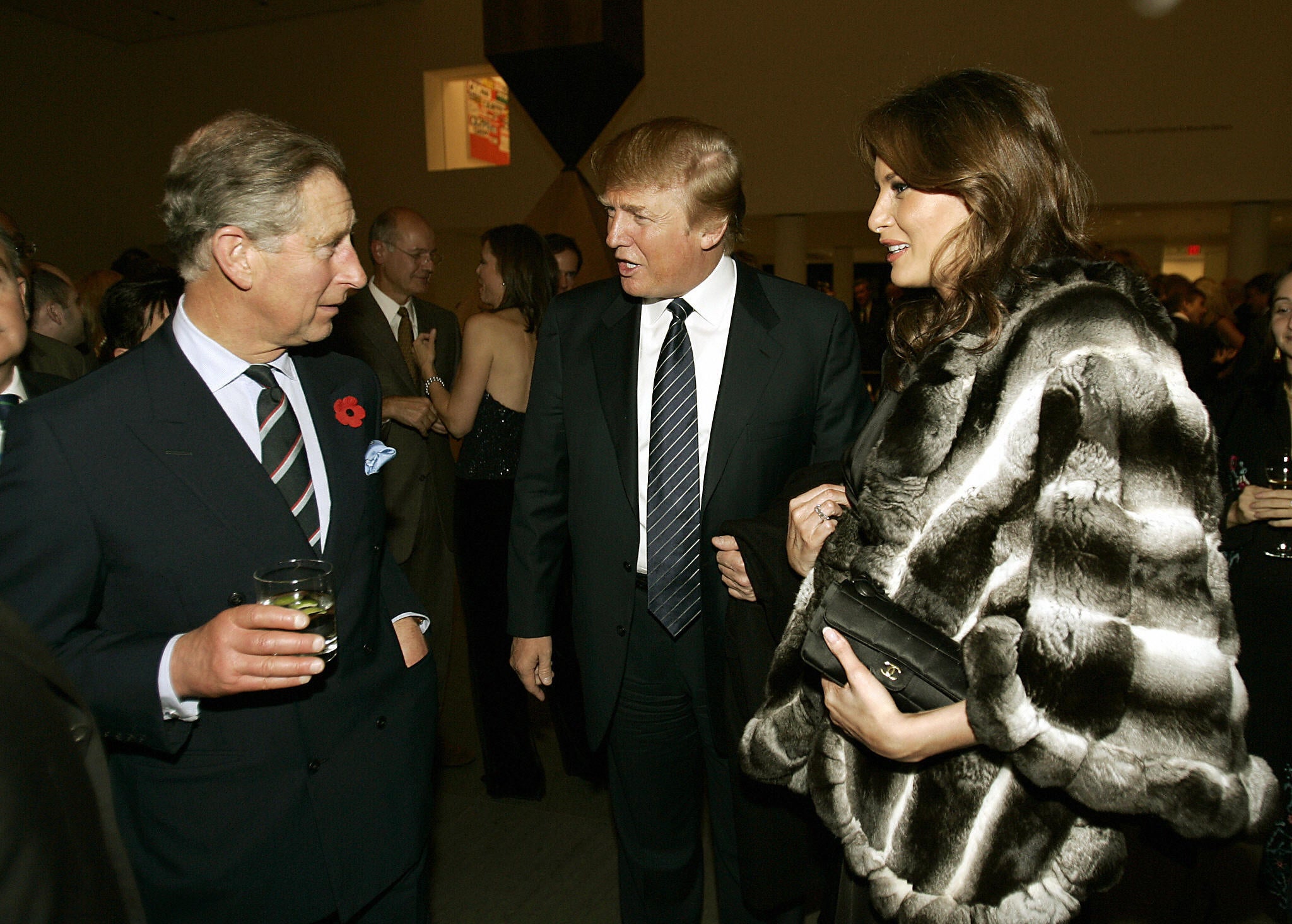 Prince Charles speaks to a future US president and first lady – Donald and Melania Trump – at the Museum of Modern Art in New York in 2005