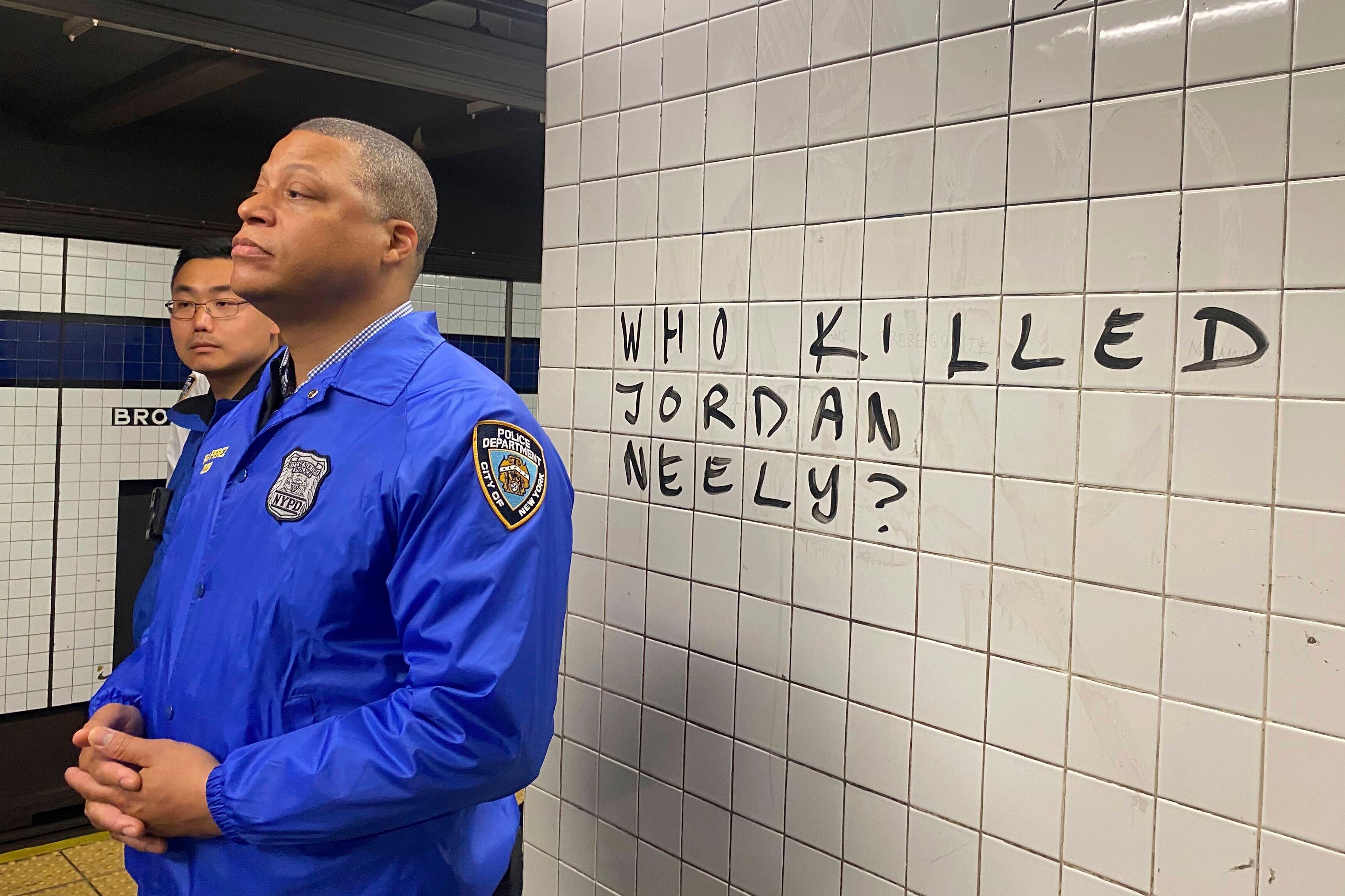 Police officers observe a crowd of protesters on a subway platform in Manhattan on 3 May