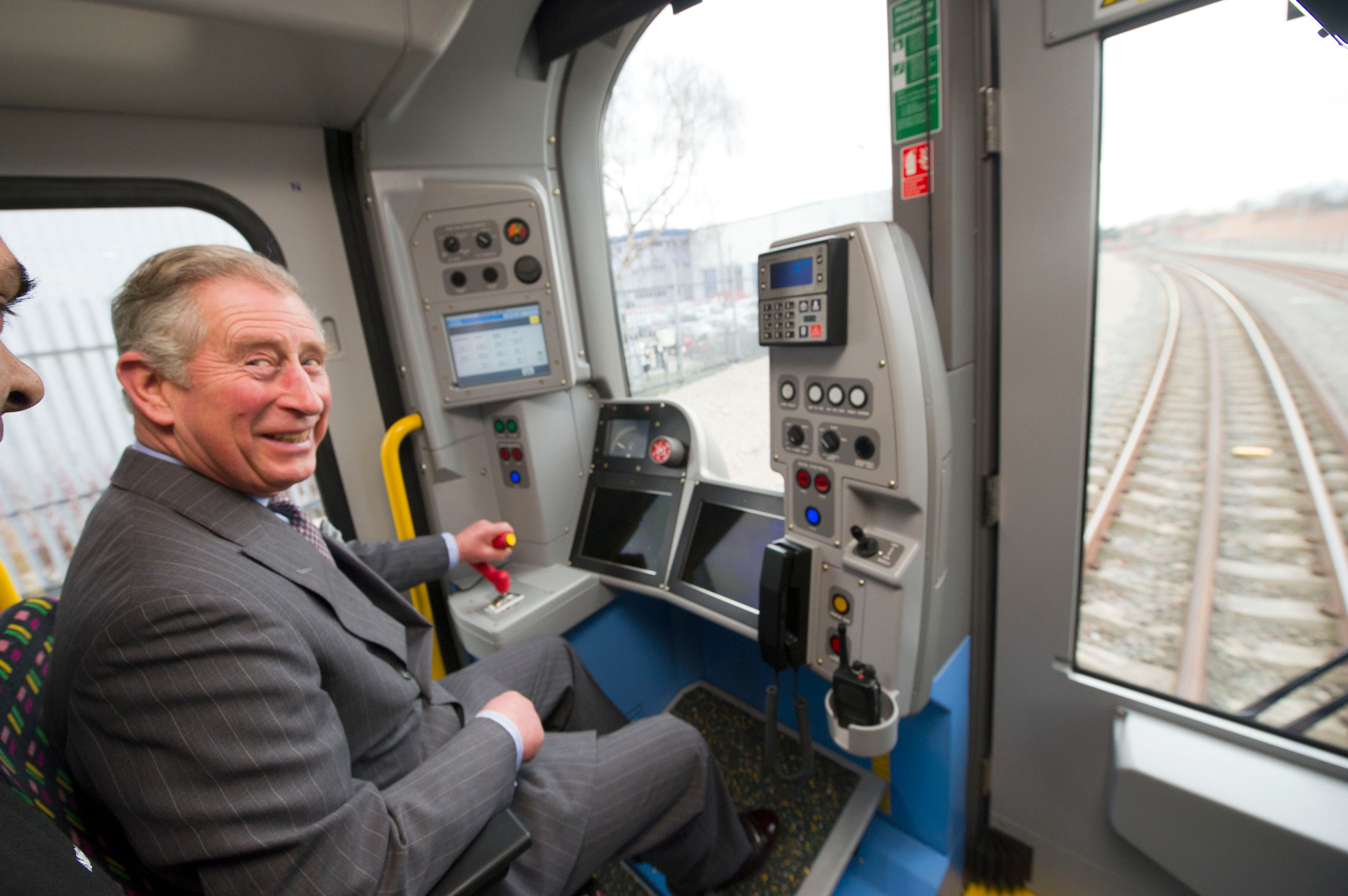 Charles, then-Prince of Wales, is shown how to drive a London Underground tube train during a visit to Bombardier Transportation, where he toured the facilities and met employees working on London Underground tube trains, on February 24, 2012