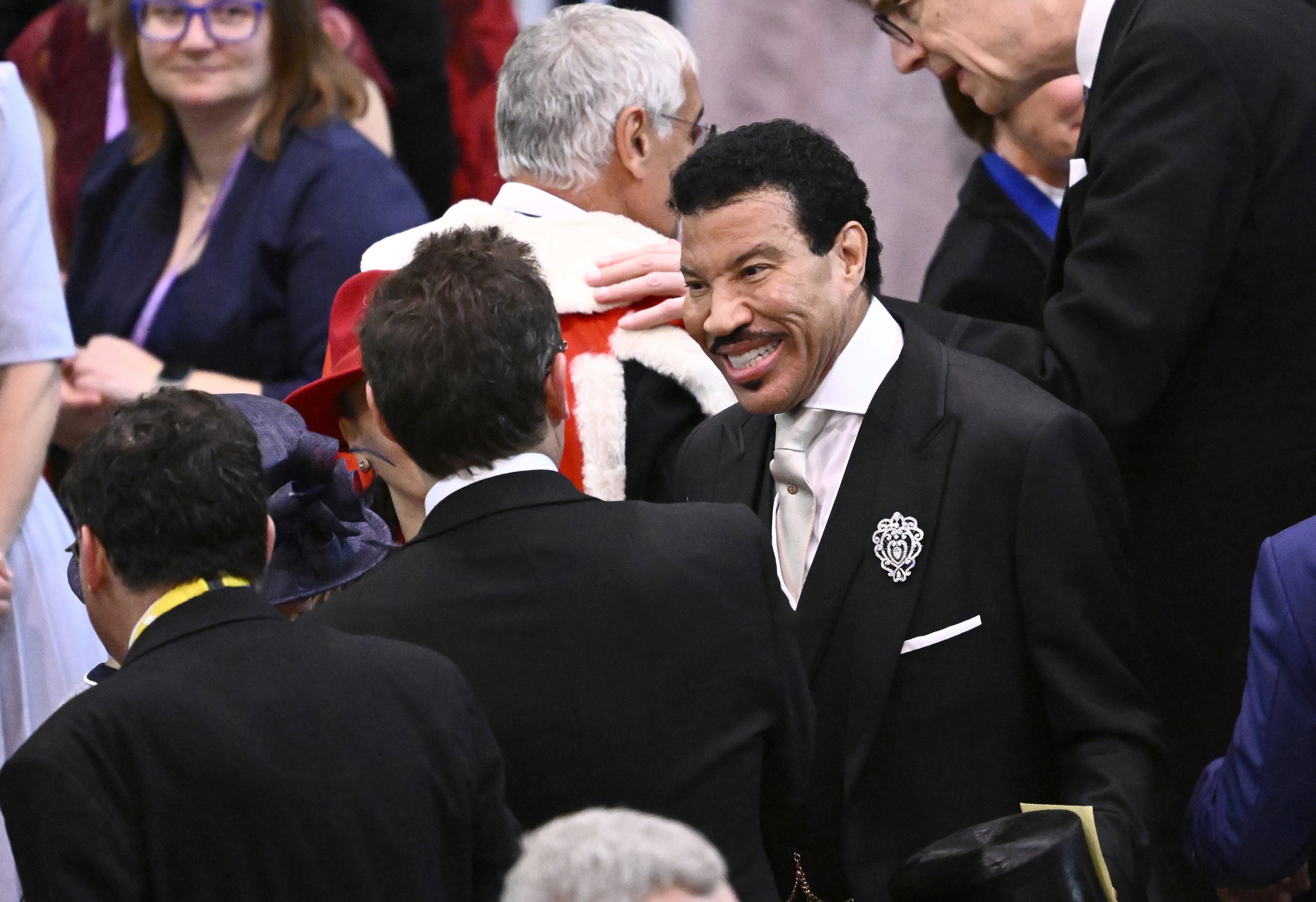 Lionel Richie shares a laugh with other guests at the ceremony