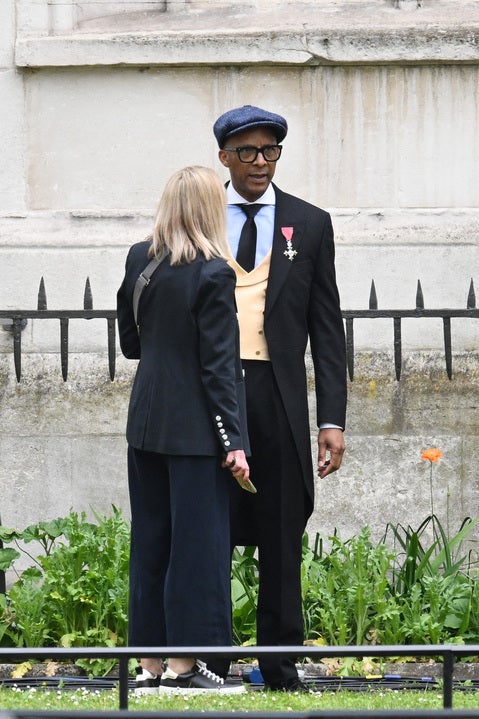 Jay Blades talks with a woman near Westminster Abbey