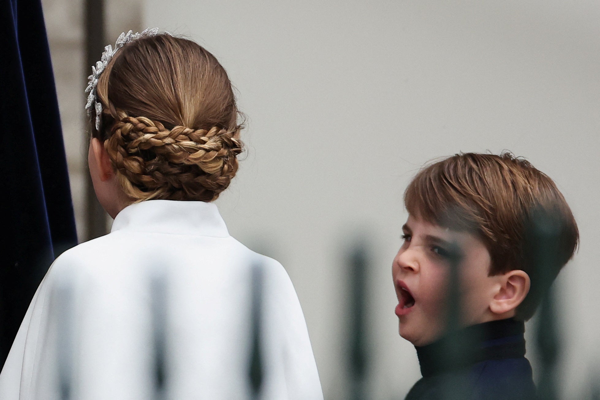 Prince Louis yawns as he stands with his sister, Princess Charlotte