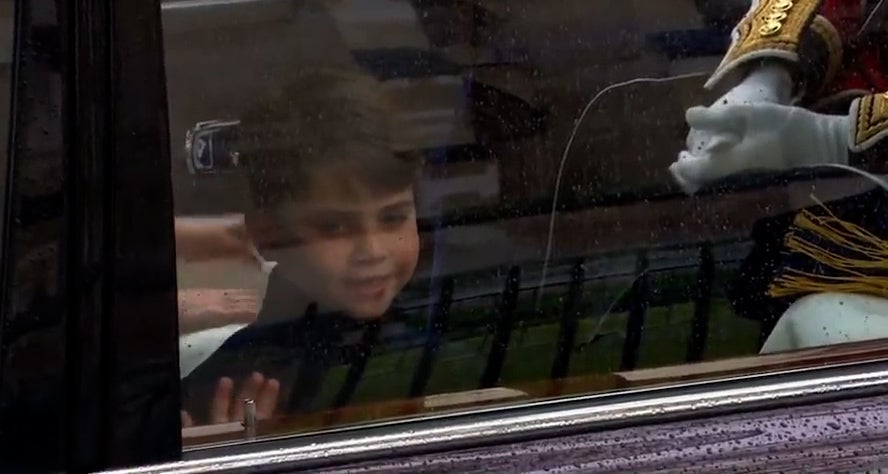 The young prince waves at the coronation crowd as he travels to Westminster Abbey