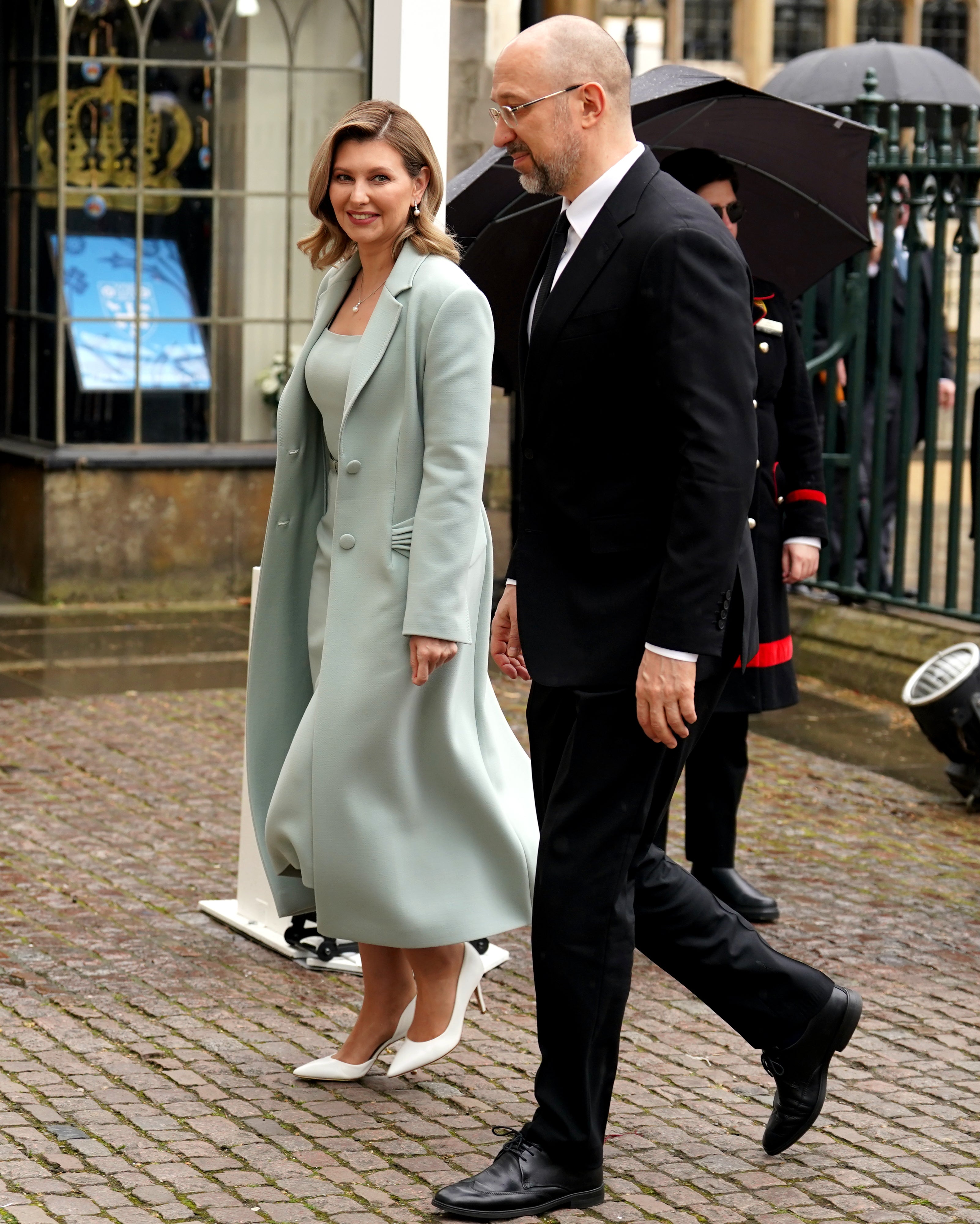 She completed the sleek look with a pair of white high heels