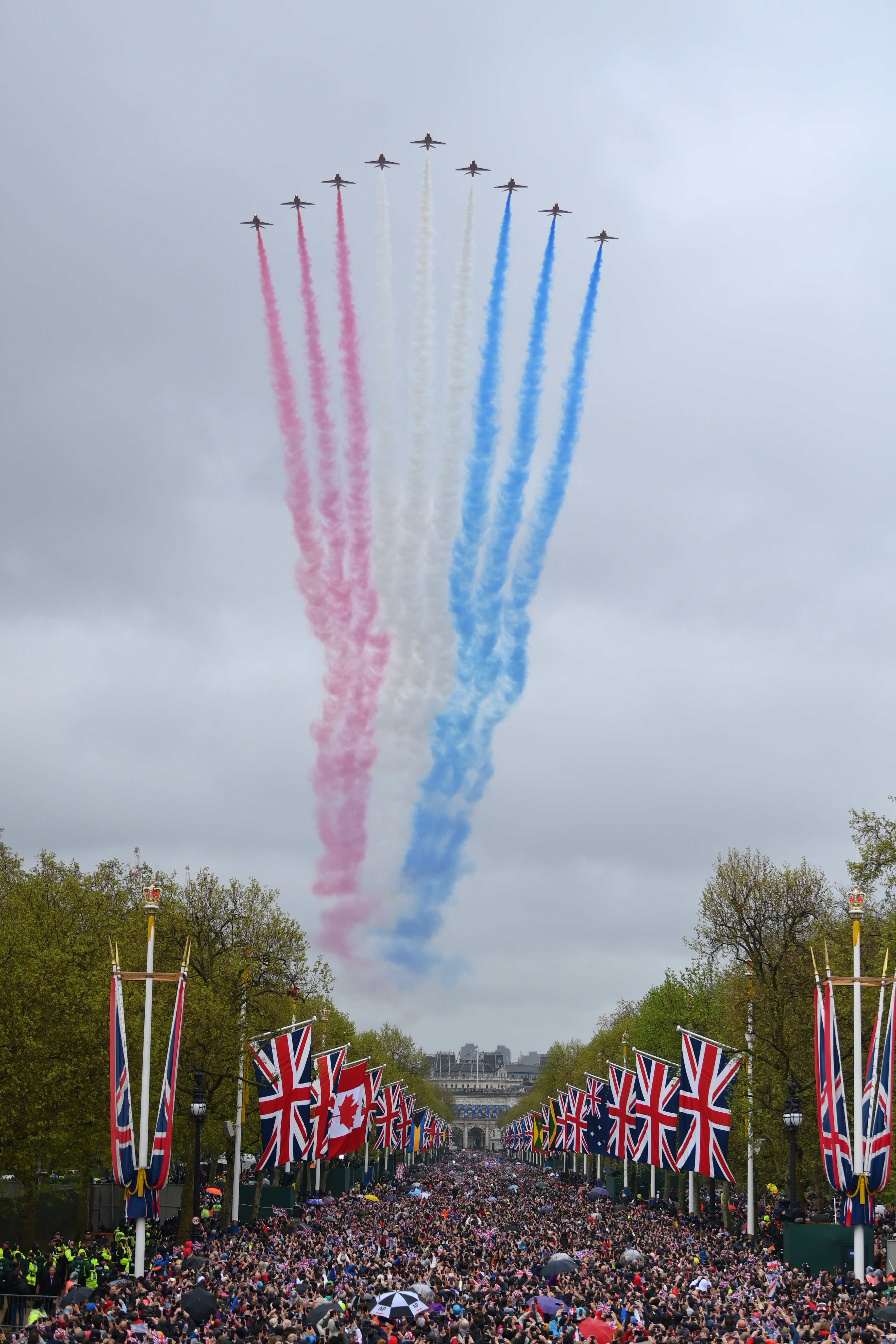 The Red Arrows fly over The Mall as huge crowds gathered for the King