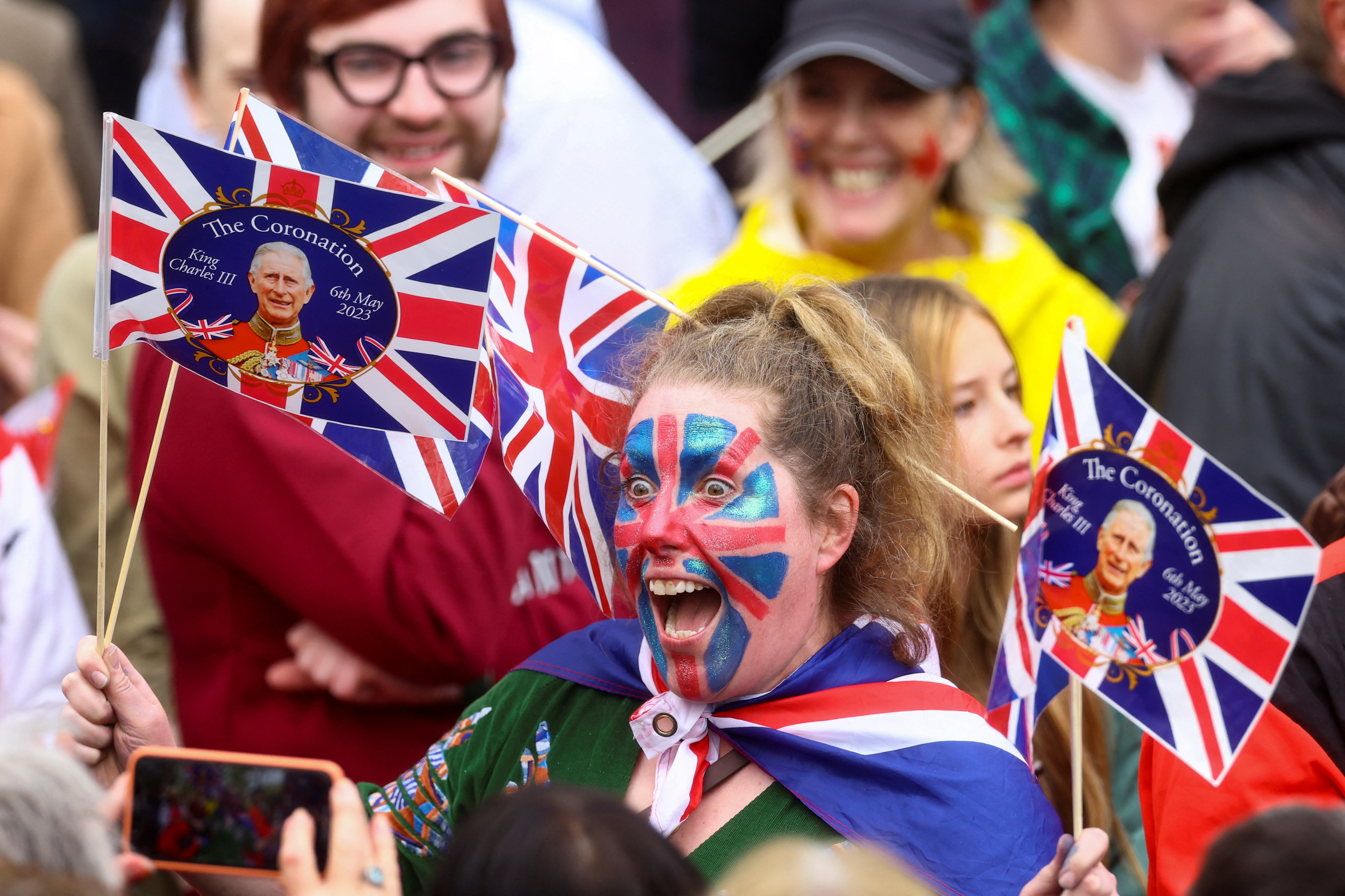 A royal fan celebrates the coronation outside the Mall