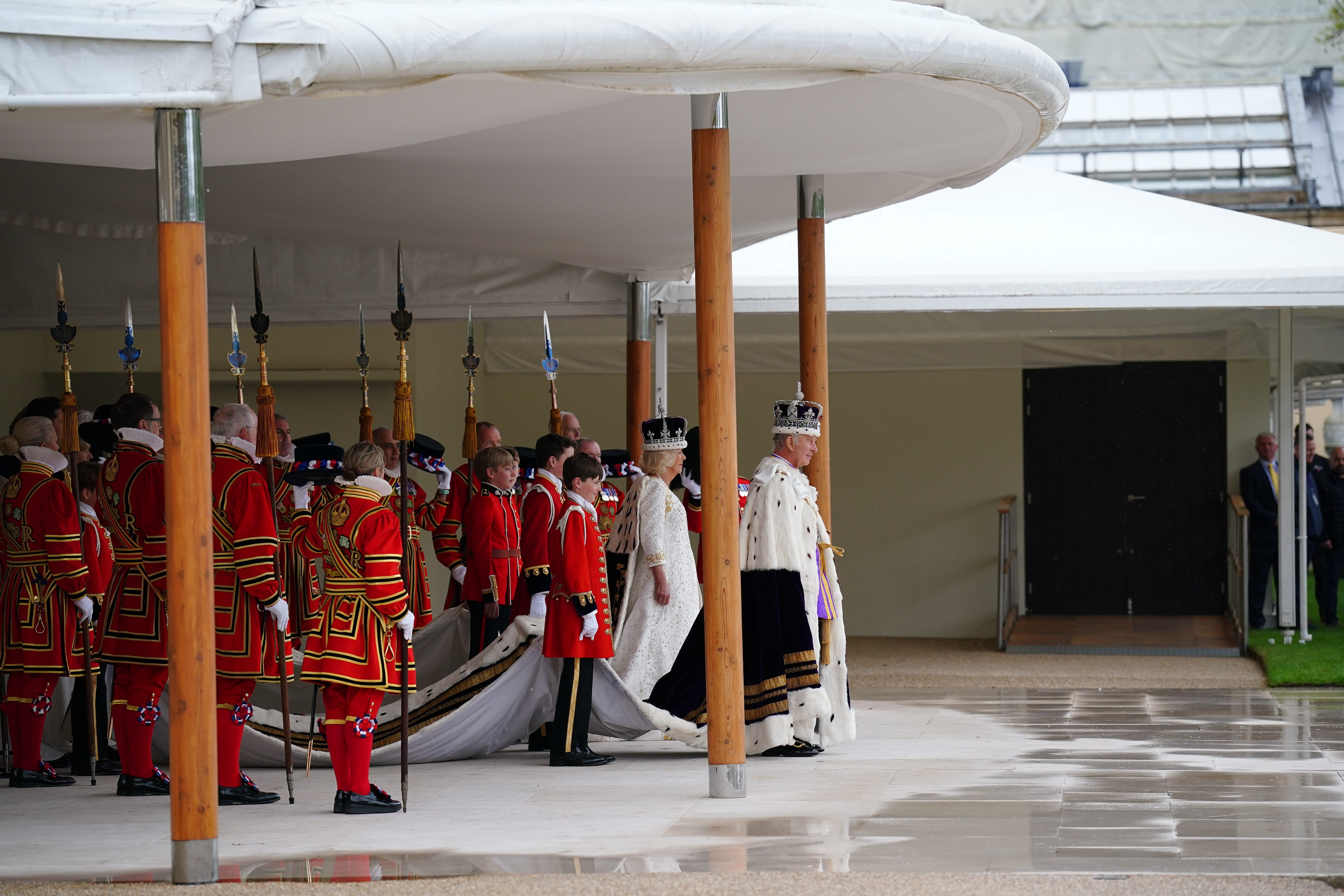 The King and Queen receive a royal salute from members of the military in the gardens of Buckingham Palace (Peter Byrne/PA)