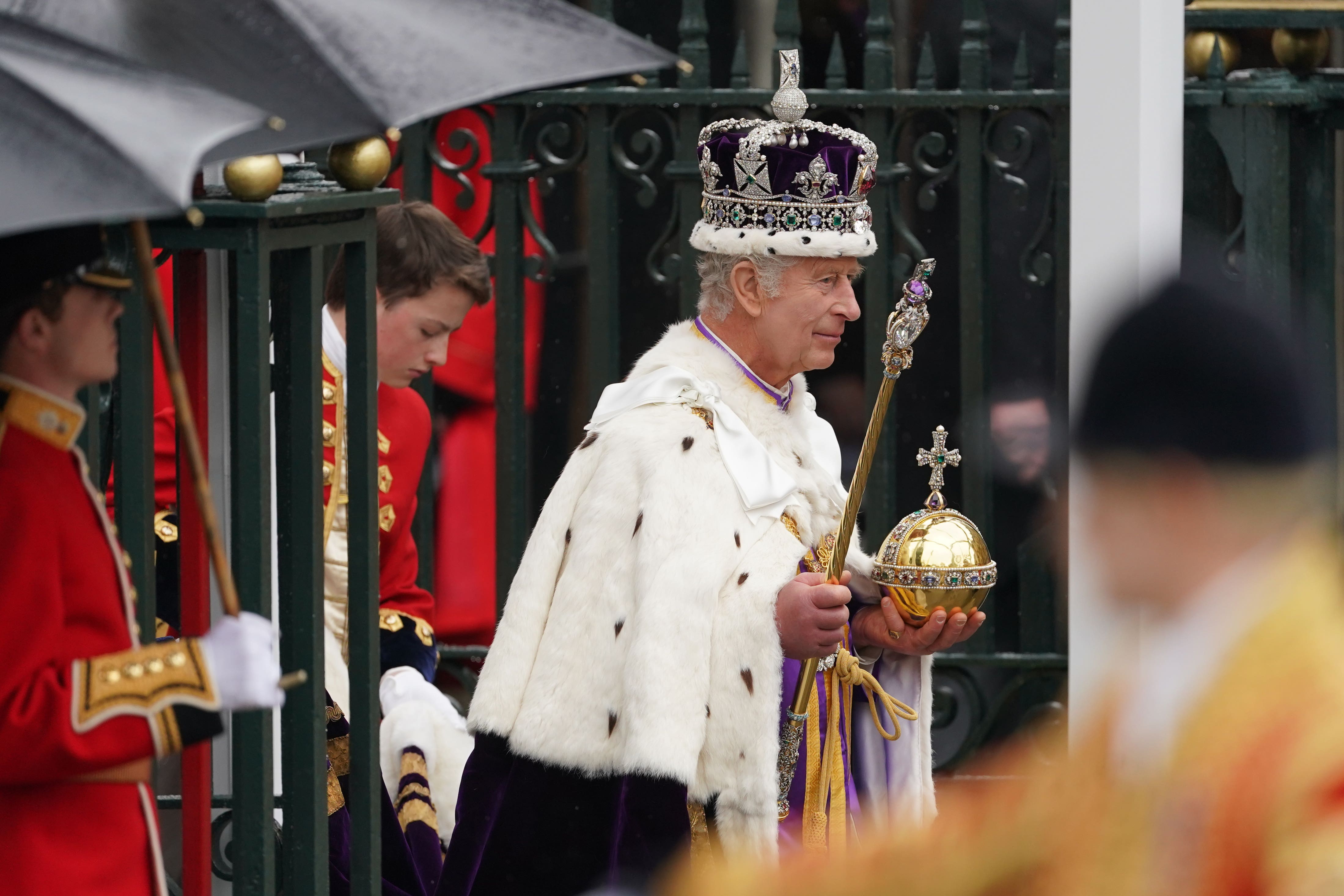 The King, wearing the Imperial State Crown, leaves Westminster Abbey (Joe Giddens/PA)