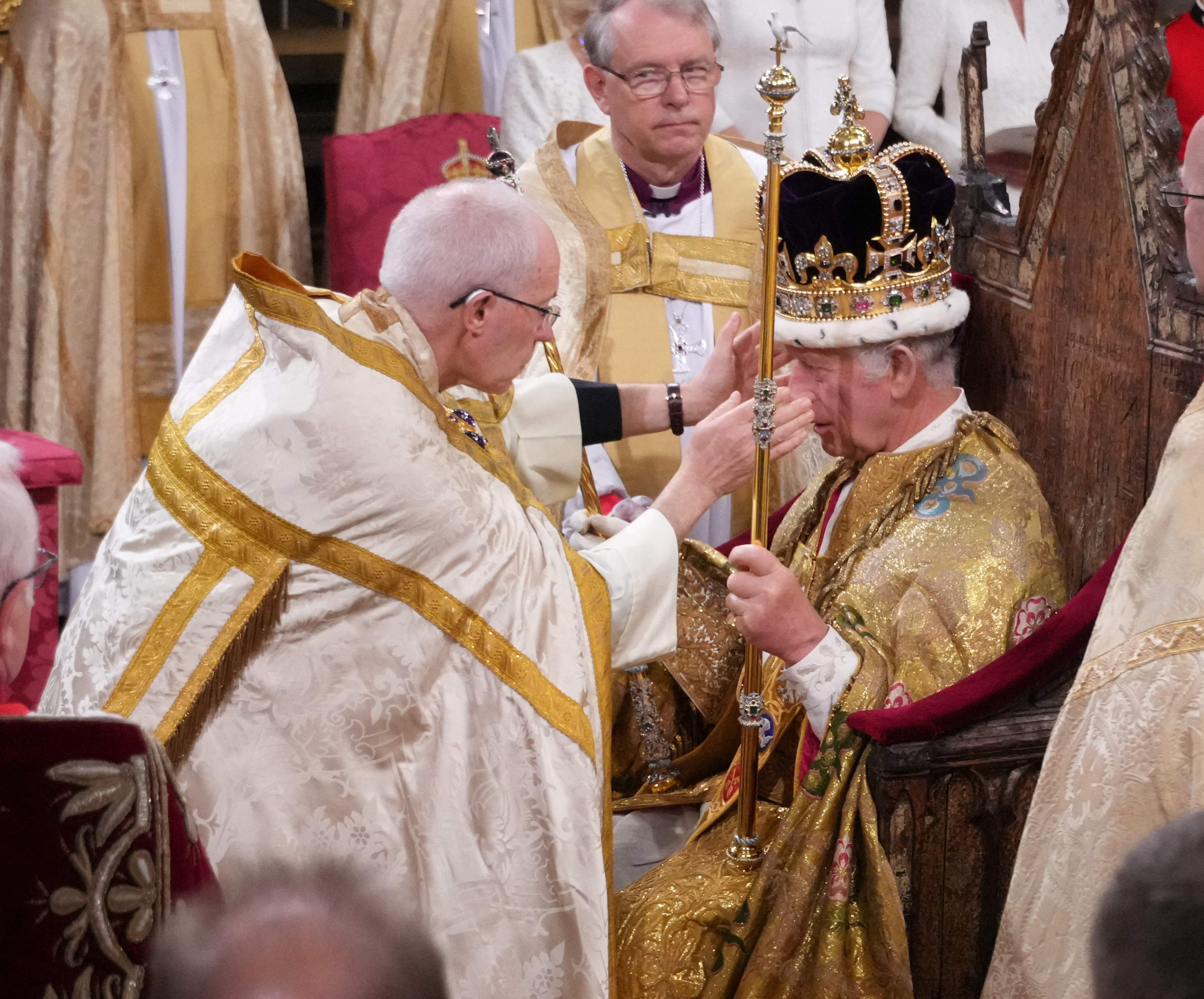 Archbishop of Canterbury Justin Welby carefully places St Edward’s Crown onto the head of King Charles at Westminster Abbey