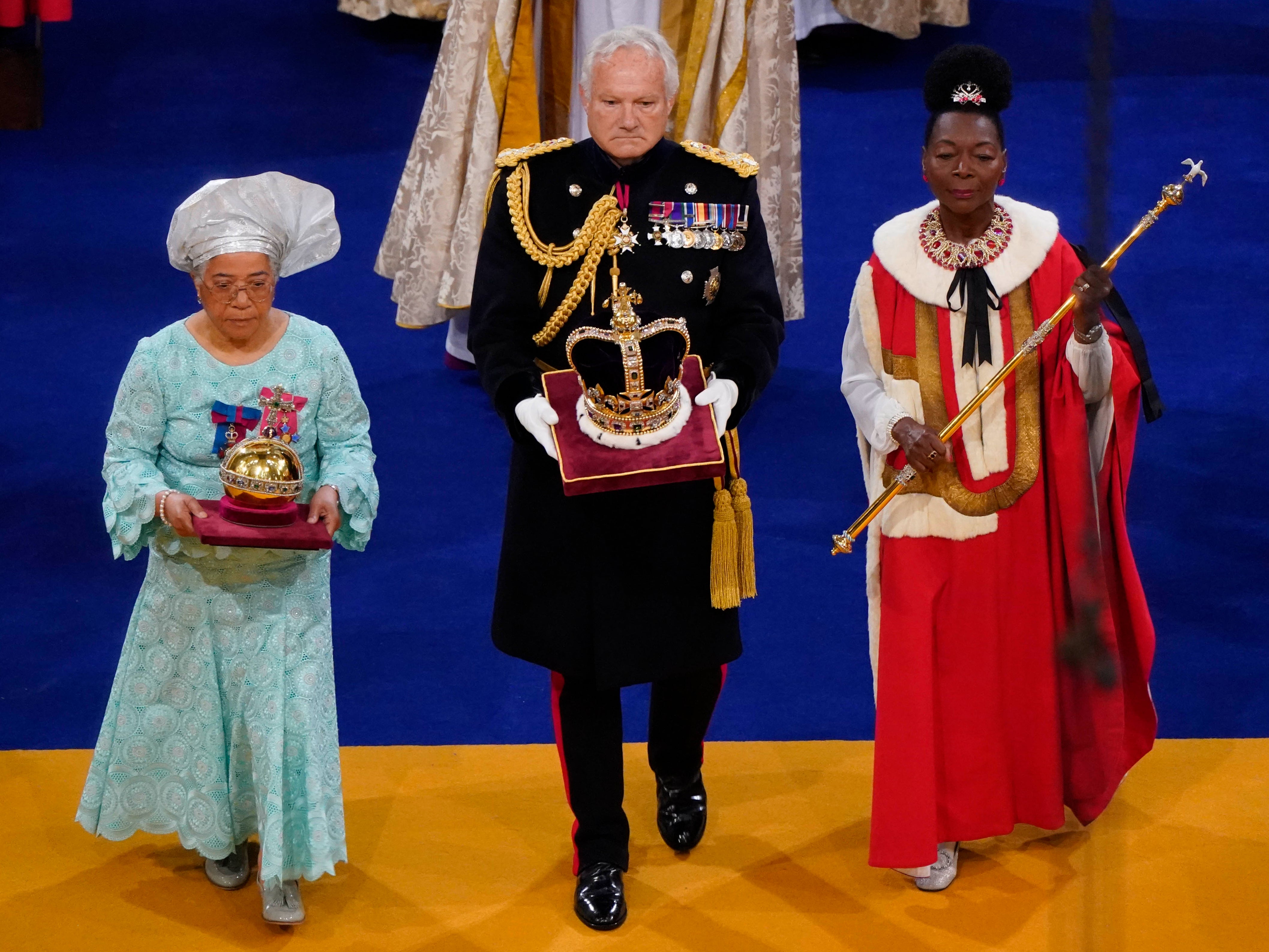 Baroness Floella Benjamin (R), carrying the the Sovereign’s Sceptre with Dove, General Sir Gordon Messenger, (C) the Governor of HM Tower of London, carrying St Edward’s Crown as Lord High Steward of England, and Dame Elizabeth Anionwu (L)