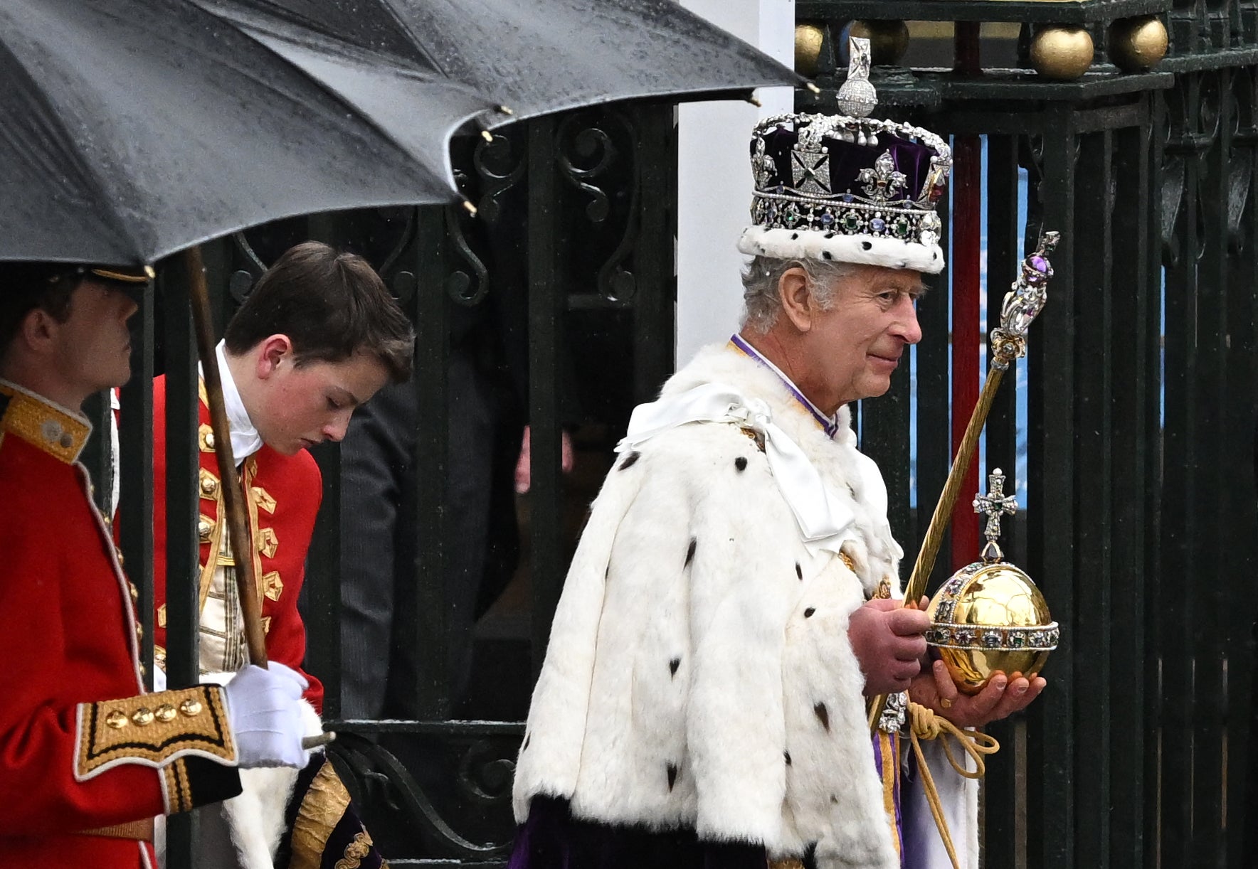 King Charles III wearing the Imperial state Crown carrying the Sovereign's Orb, leaves Westminster Abbey