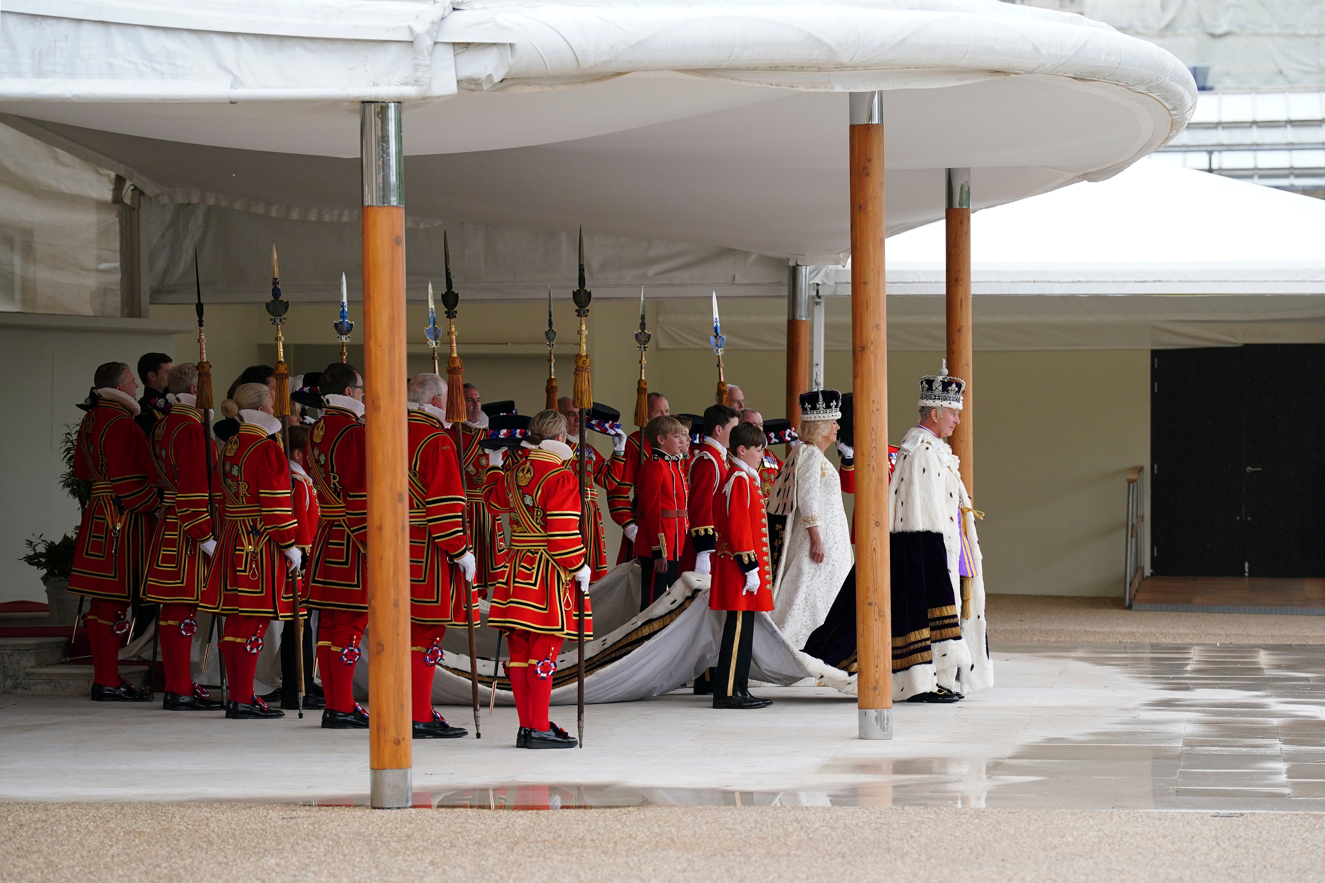 King Charles III, right, and Queen Camilla arrive to receive a royal salute from members of the military