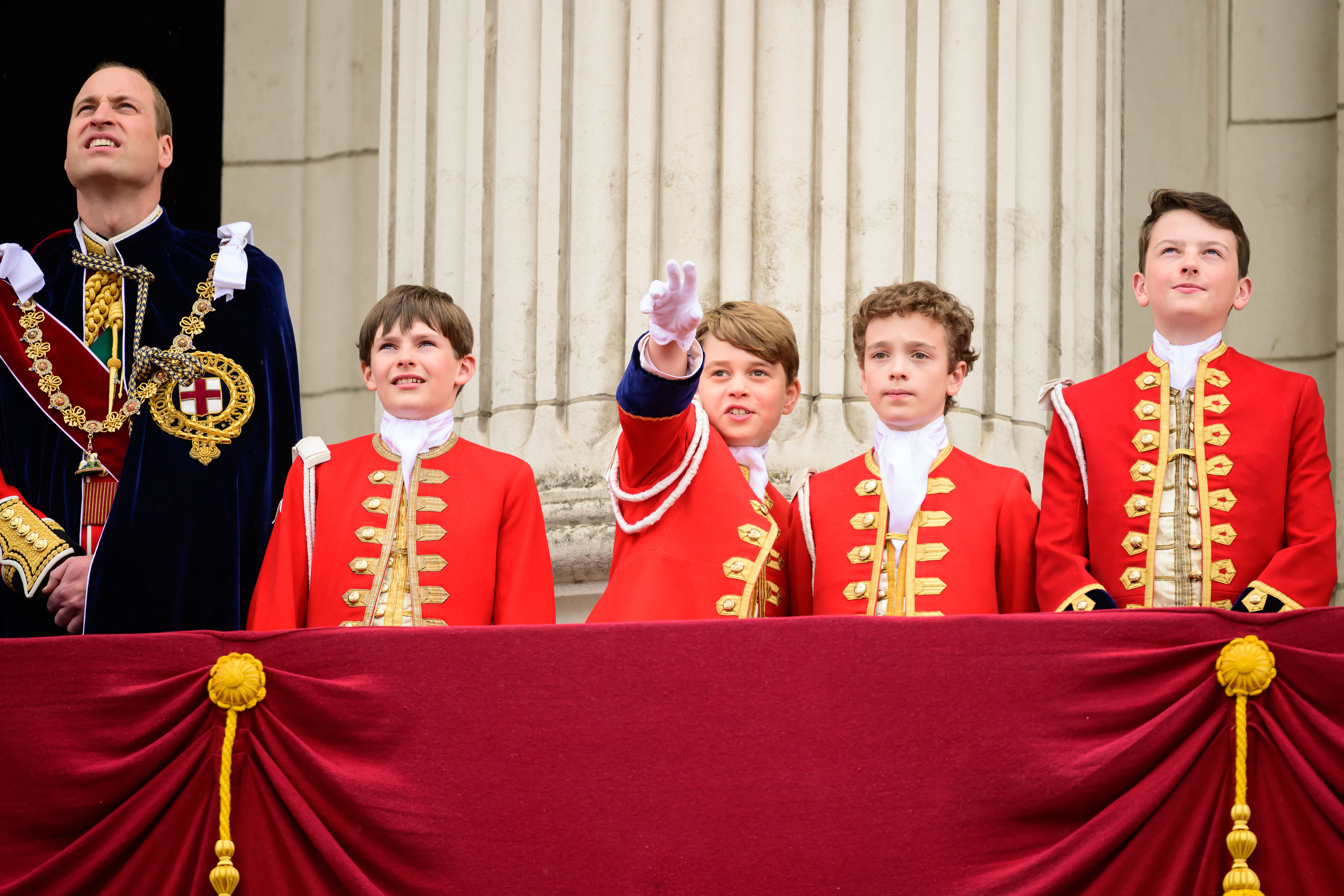 The Prince of Wales and Prince George with the King’s Pages of Honour on the balcony of Buckingham Palace following the coronation (Leon Neal/PA)