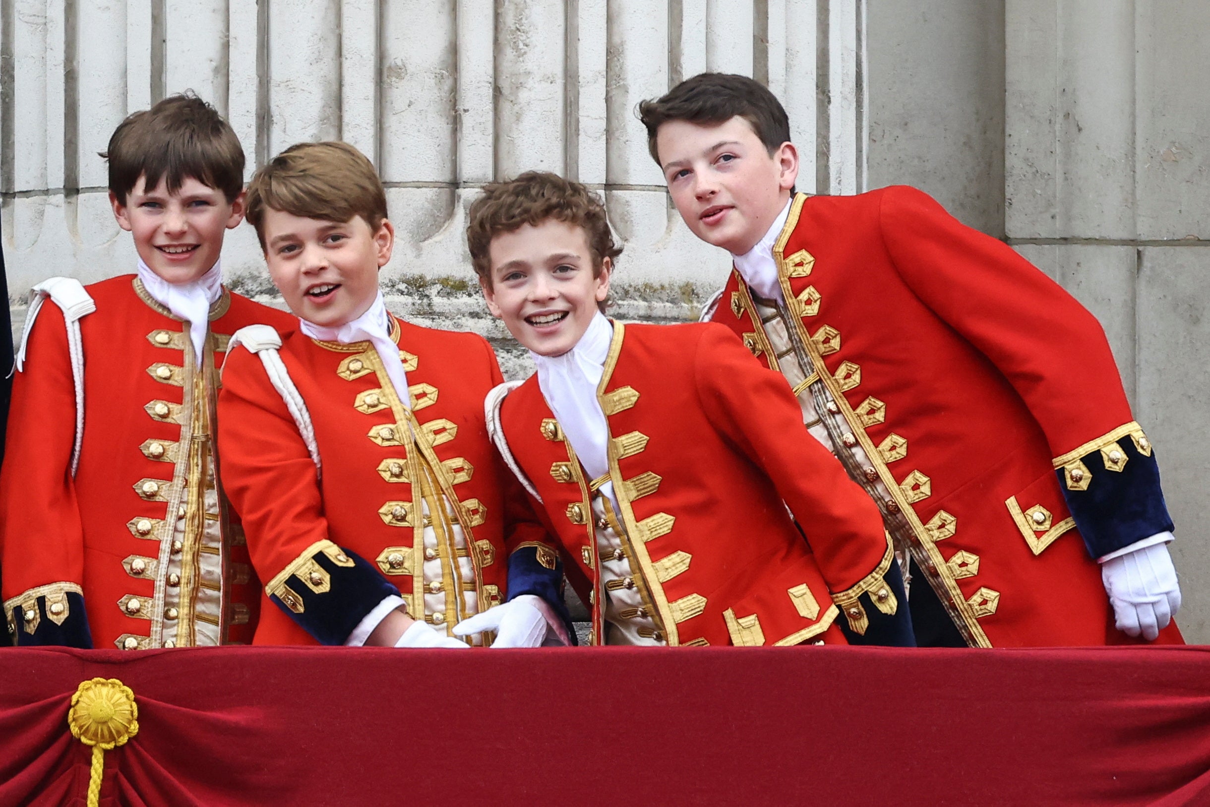 Prince George reacts as he stands on the Buckingham Palace balcony